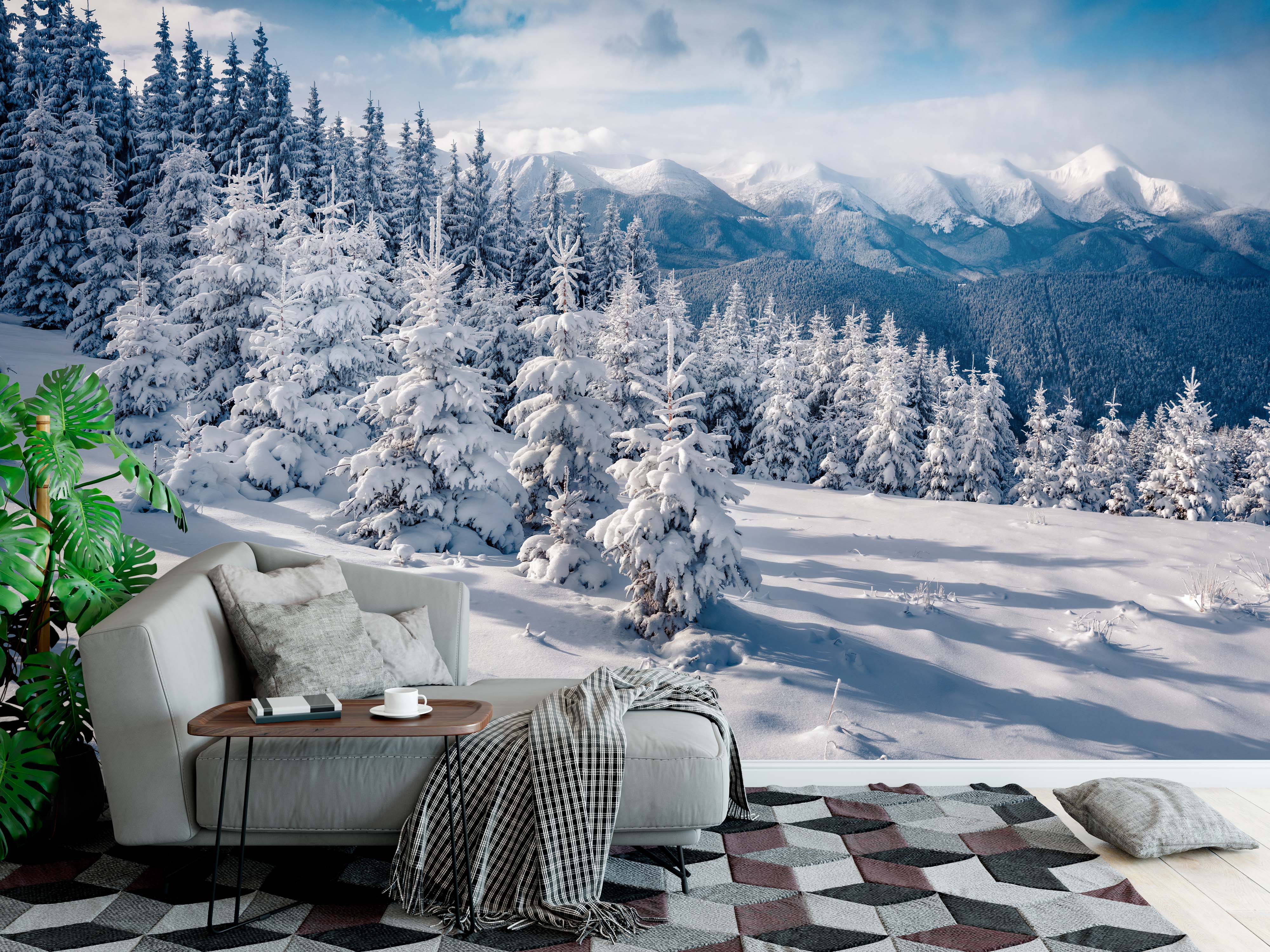 A scenic wall mural of a bright, snowy mountain landscape with evergreen trees in the foreground and peaks in the distance.