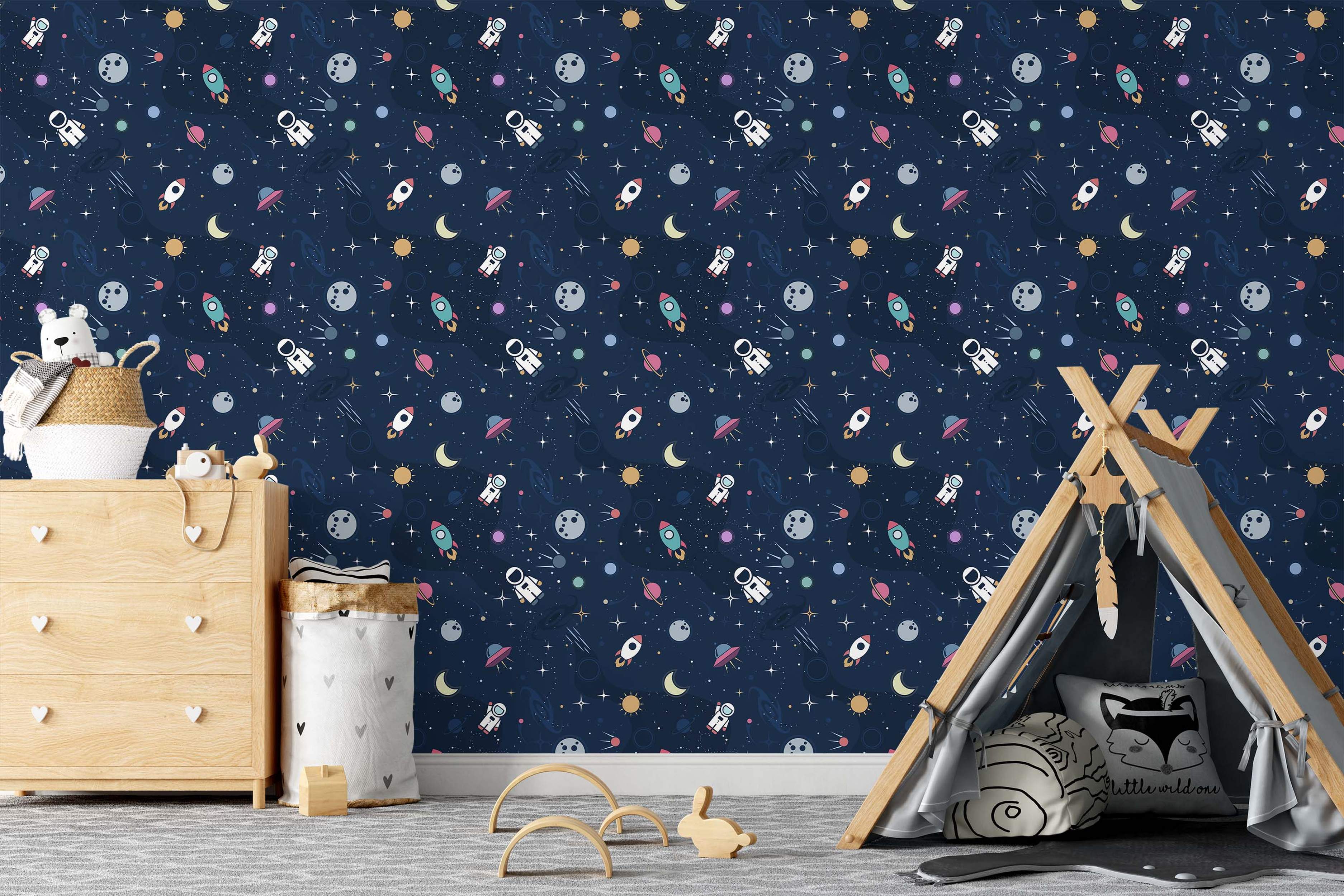 Children's space-themed wallpaper with cartoon astronauts, rockets, planets, and stars scattered on a navy blue background.
