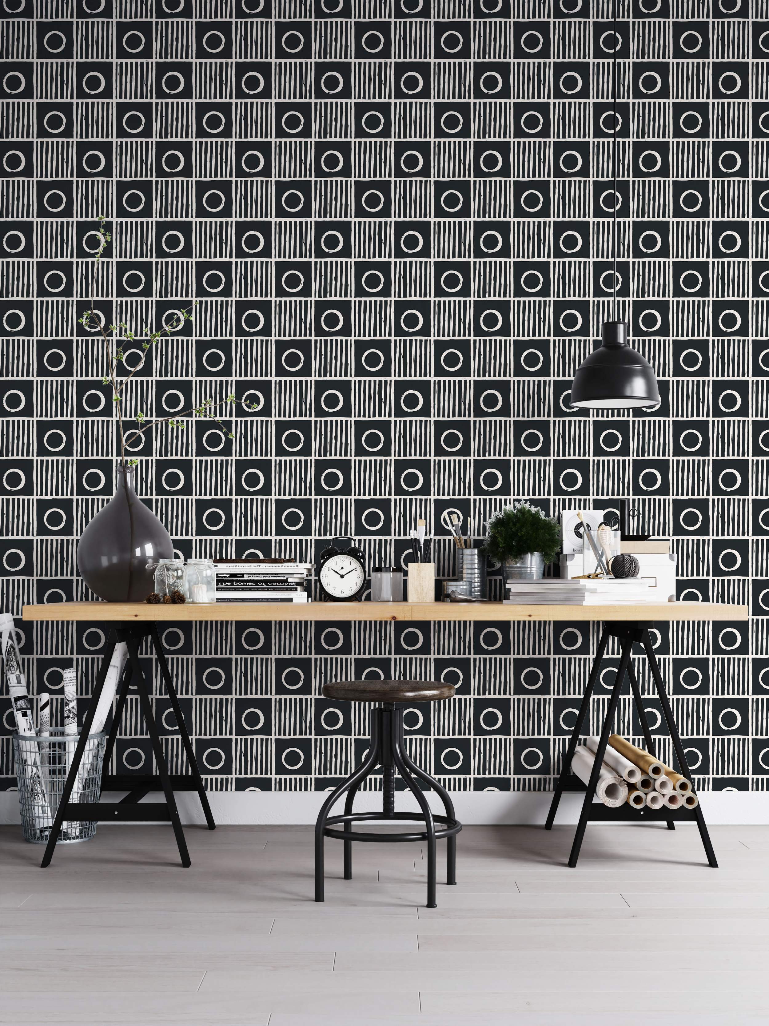 Geometric wallpaper with a grid of alternating black squares: one with a white circle, the other with vertical white stripes.