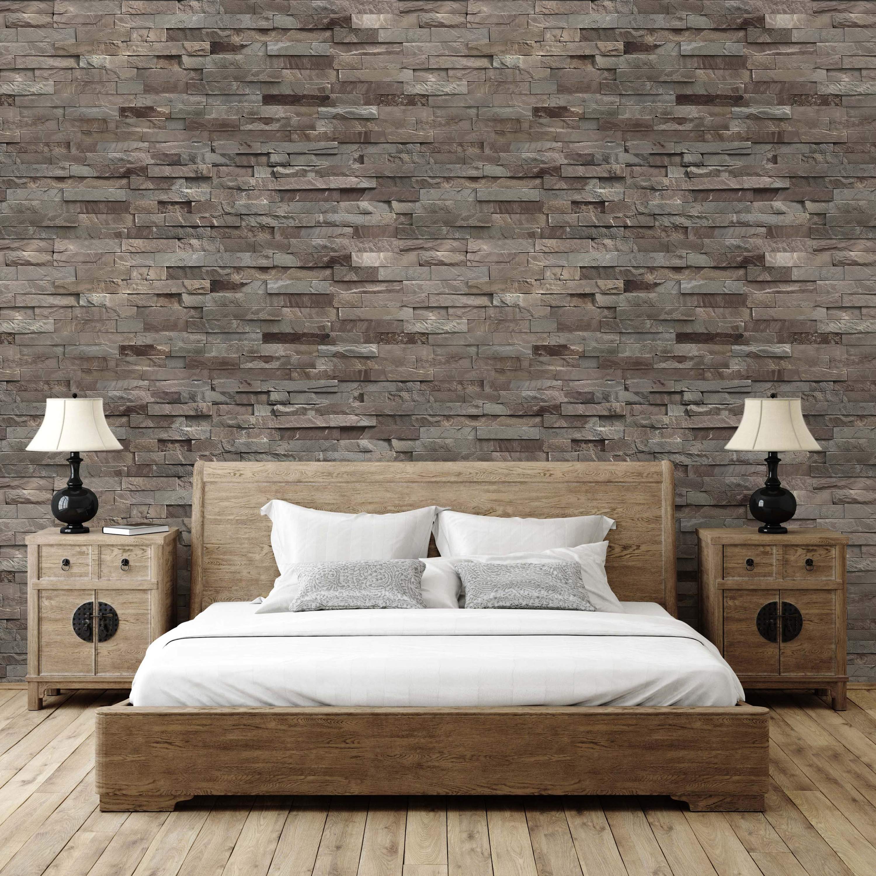 Wallpaper featuring a realistic stacked ledger stone pattern with rough-cut rectangular stones in earthy brown and gray tones.