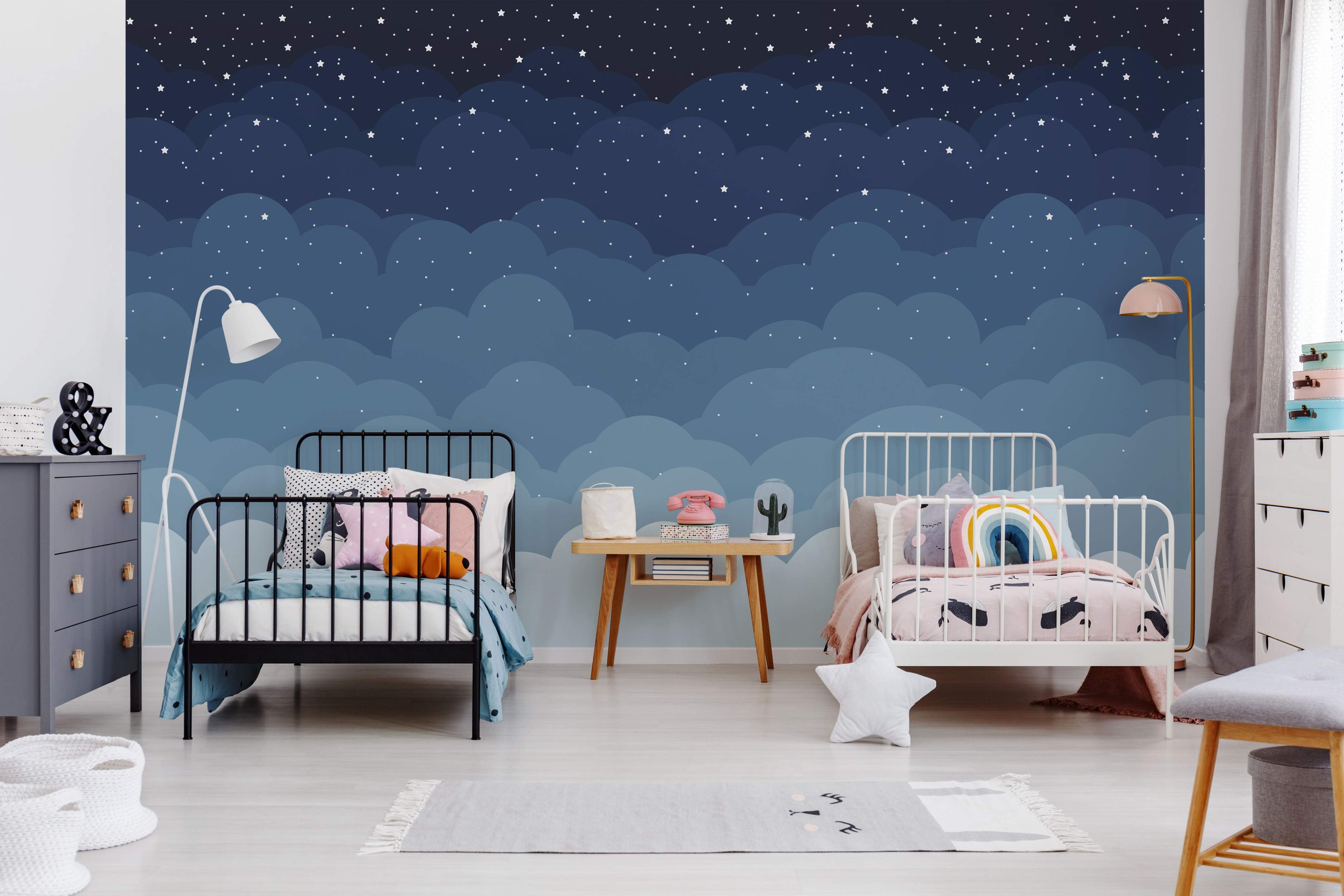 Night sky mural with stars and layered blue clouds.