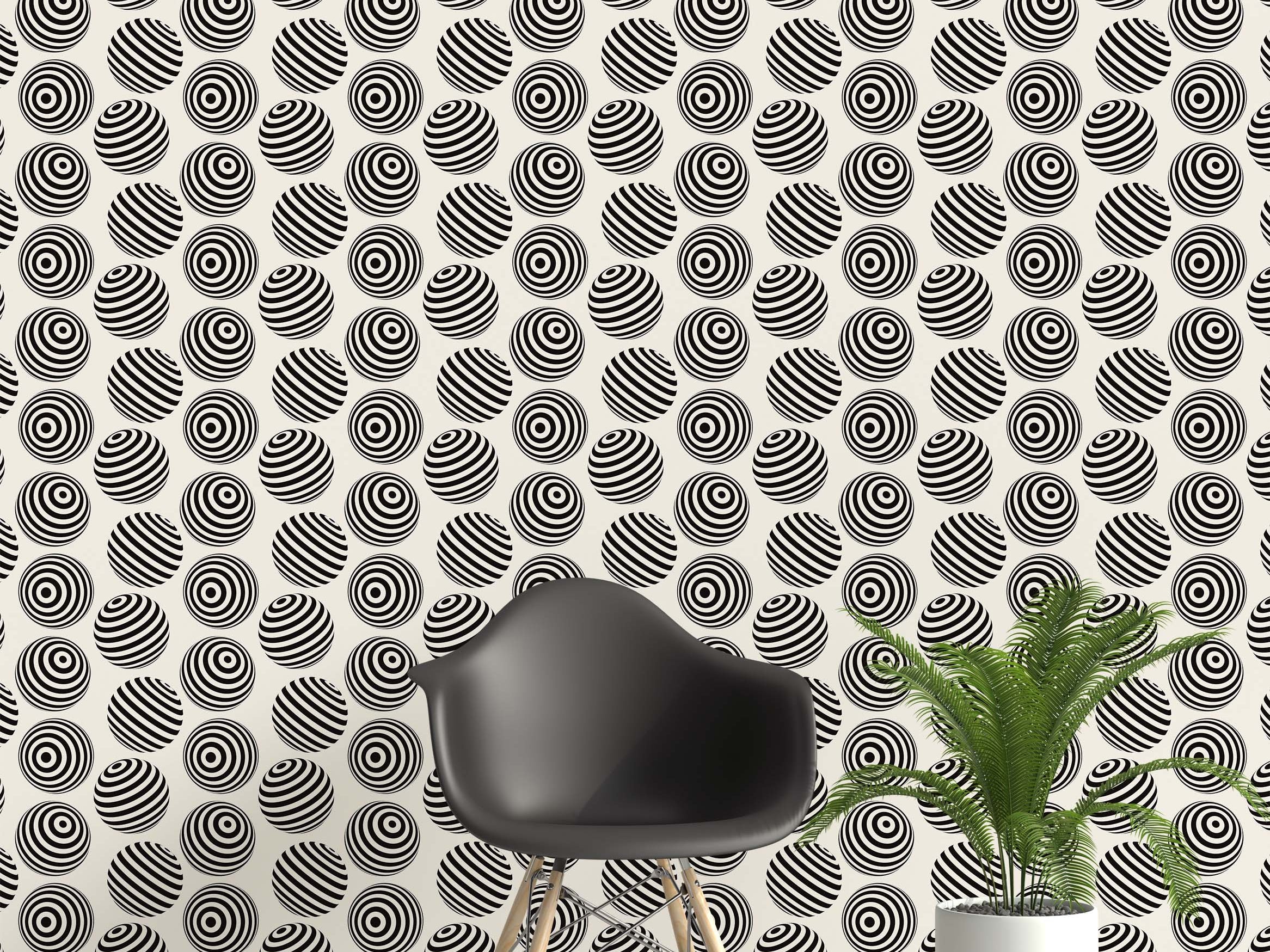 Wallpaper featuring an op art pattern of black and white spheres with stripes and concentric circles on a cream field.