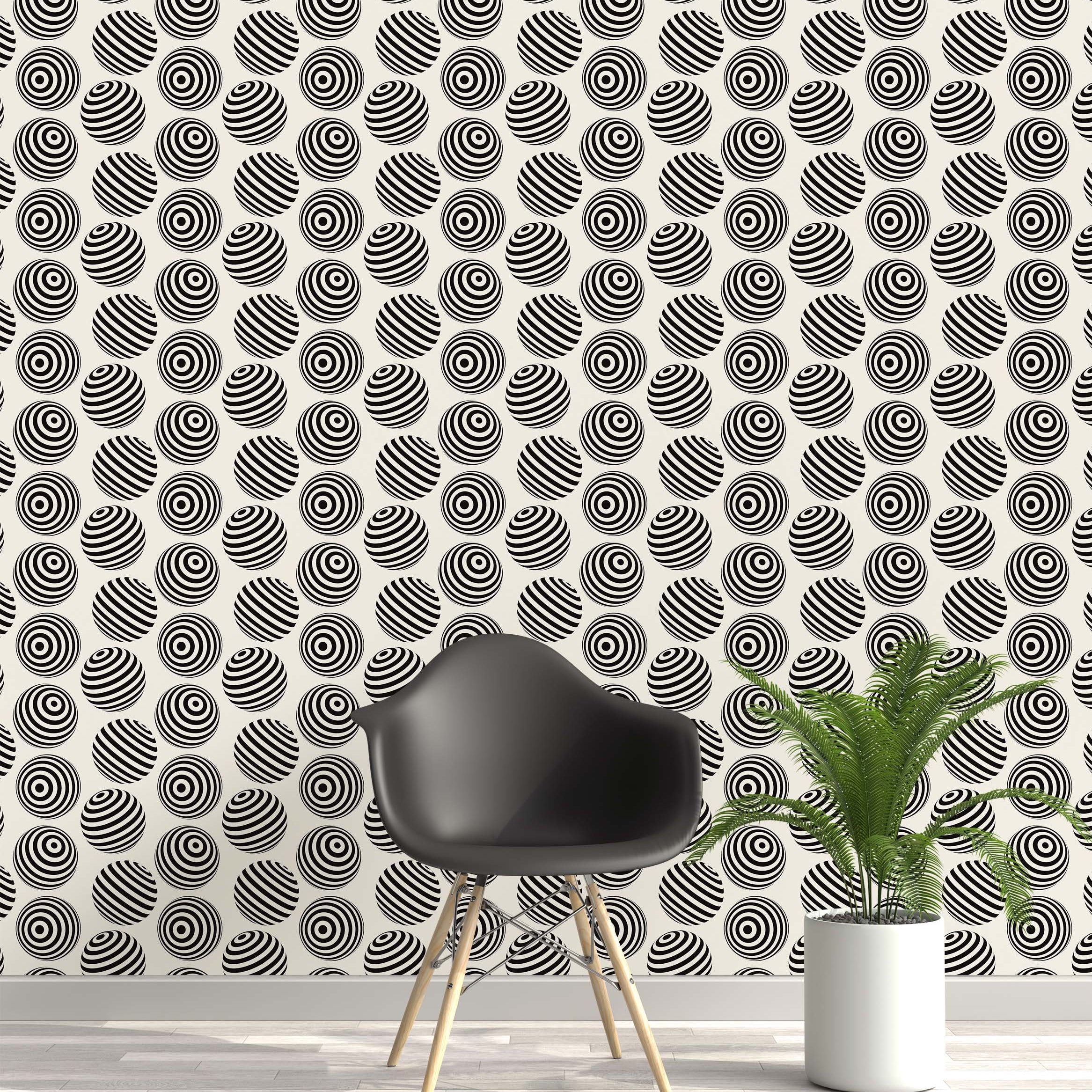 Wallpaper featuring an op art pattern of black and white spheres with stripes and concentric circles on a cream field.