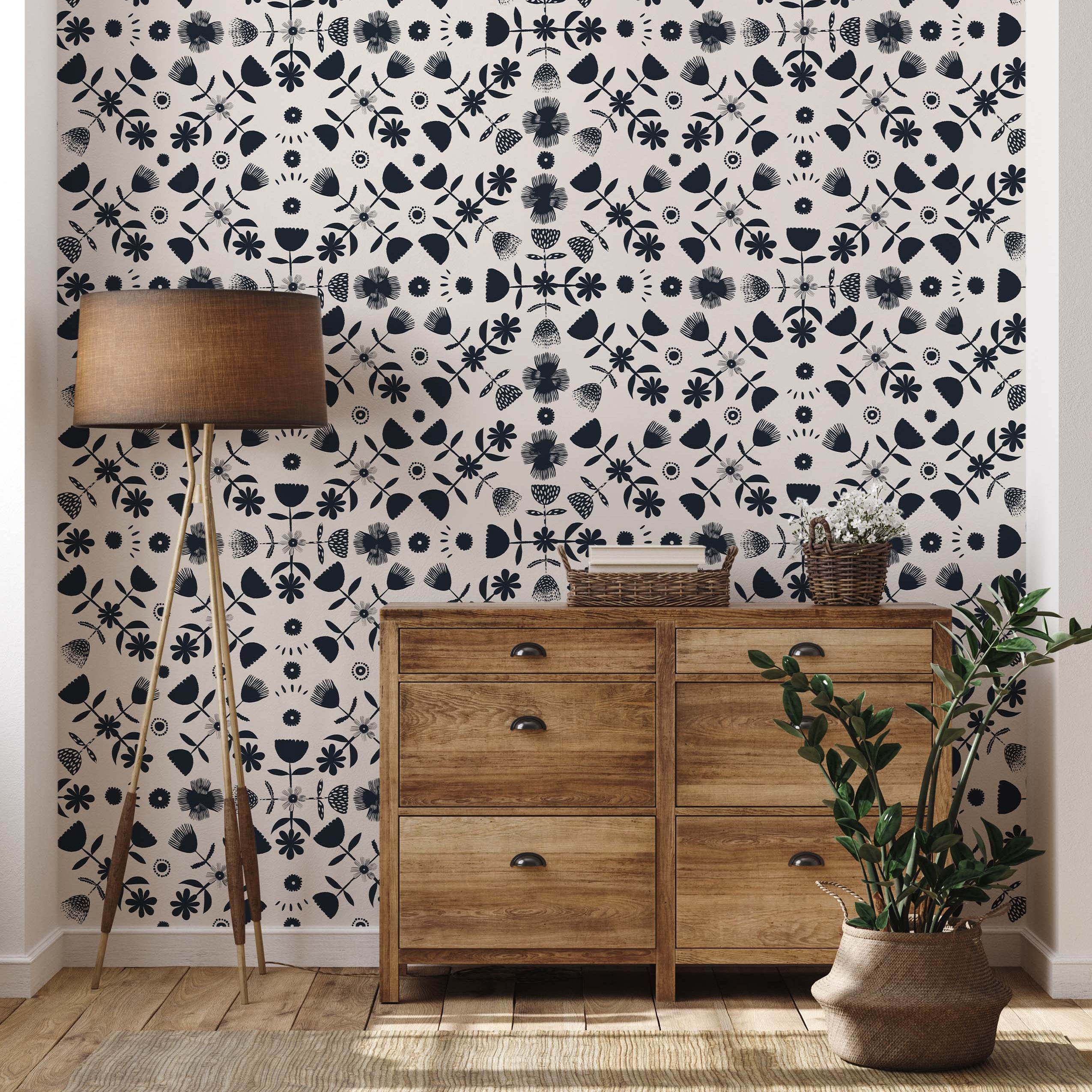 Cream wallpaper with a grid pattern of navy blue stylized floral and abstract folk-art motifs.