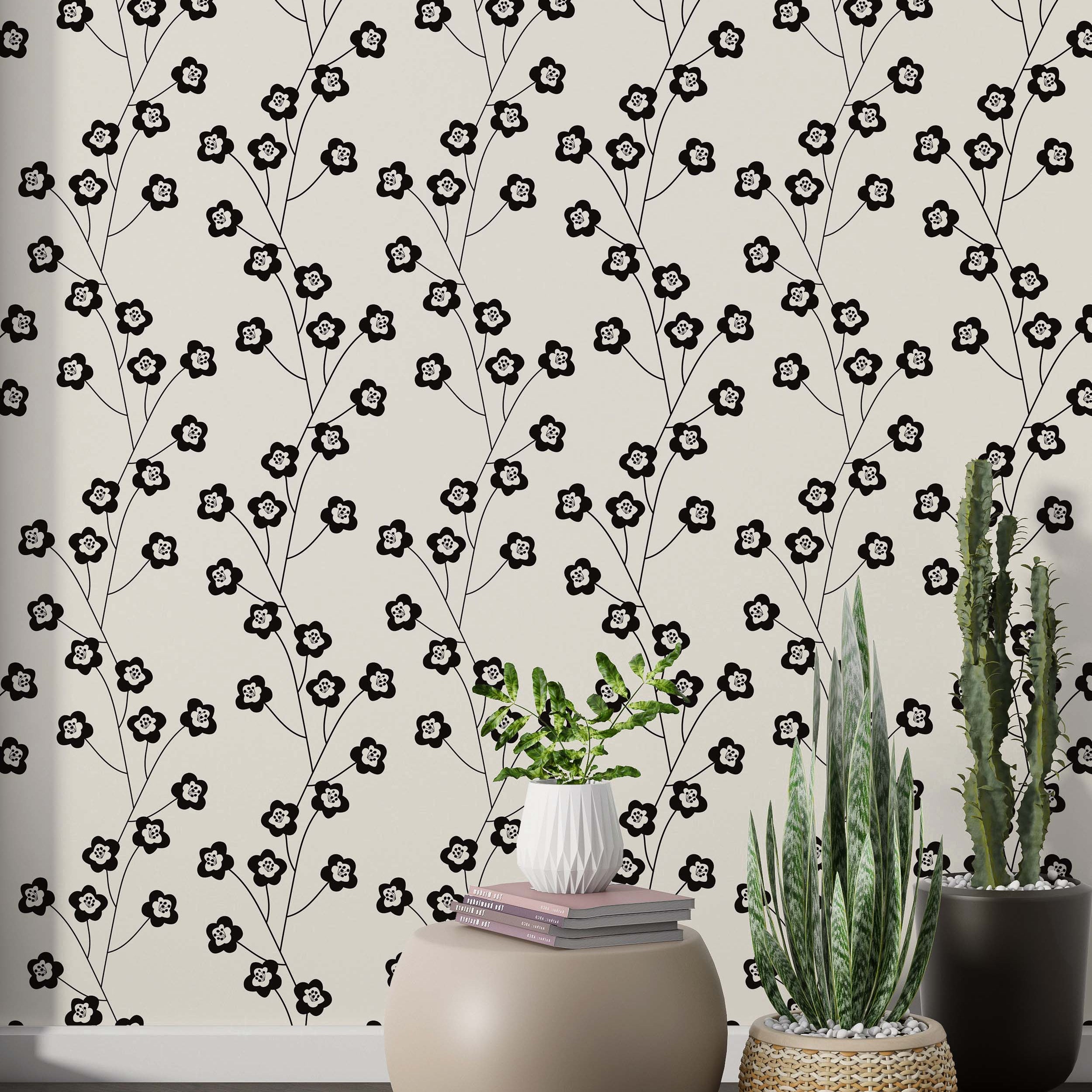 Repeating wallpaper featuring stylized black floral vines with white-centered flowers on a light beige background.