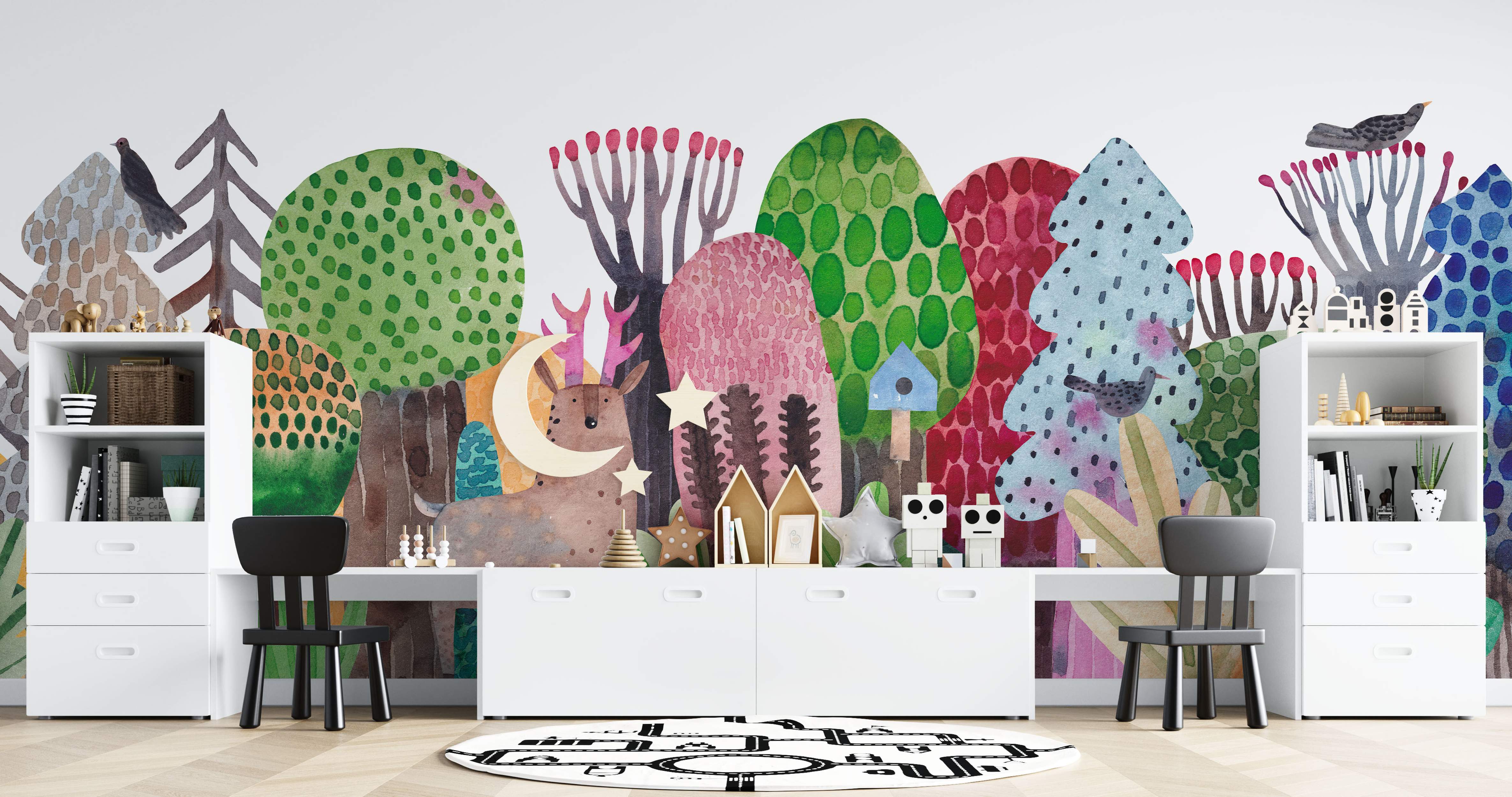 Whimsical watercolor mural featuring stylized trees, hills, a deer, birds, moon, and stars in green, pink, blue, brown, and gray.