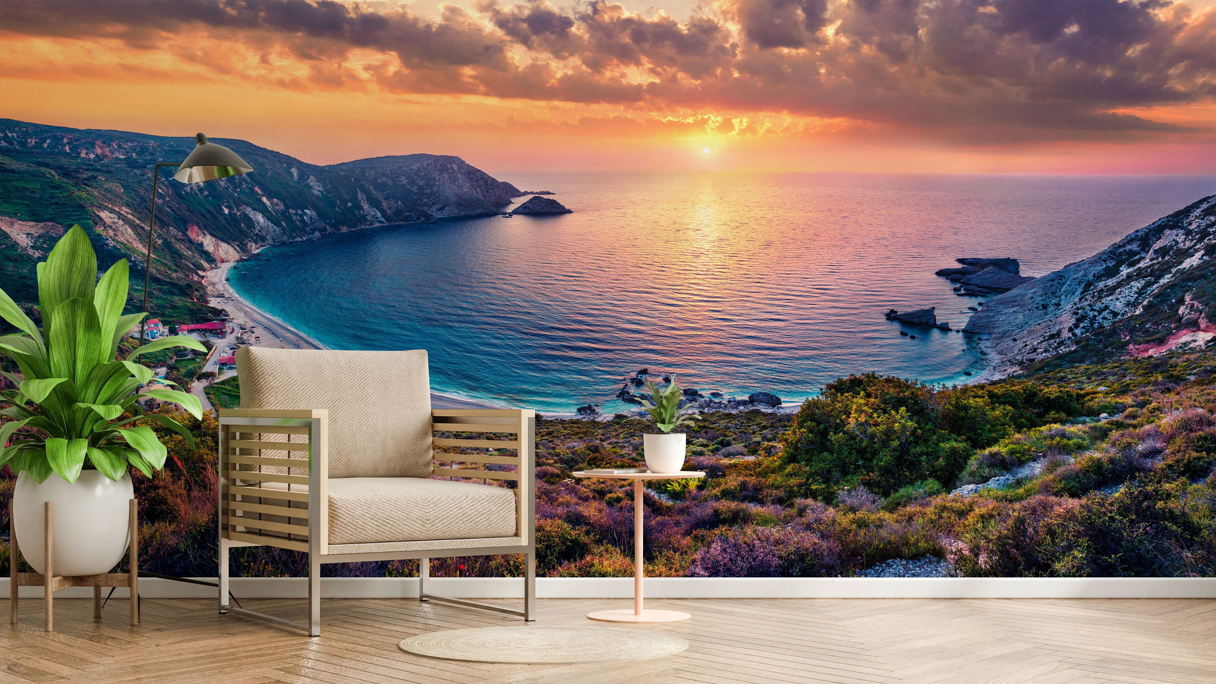 Realistic coastal landscape mural showing a vibrant orange and pink sunset over a blue sea bay, cliffs, and beach.