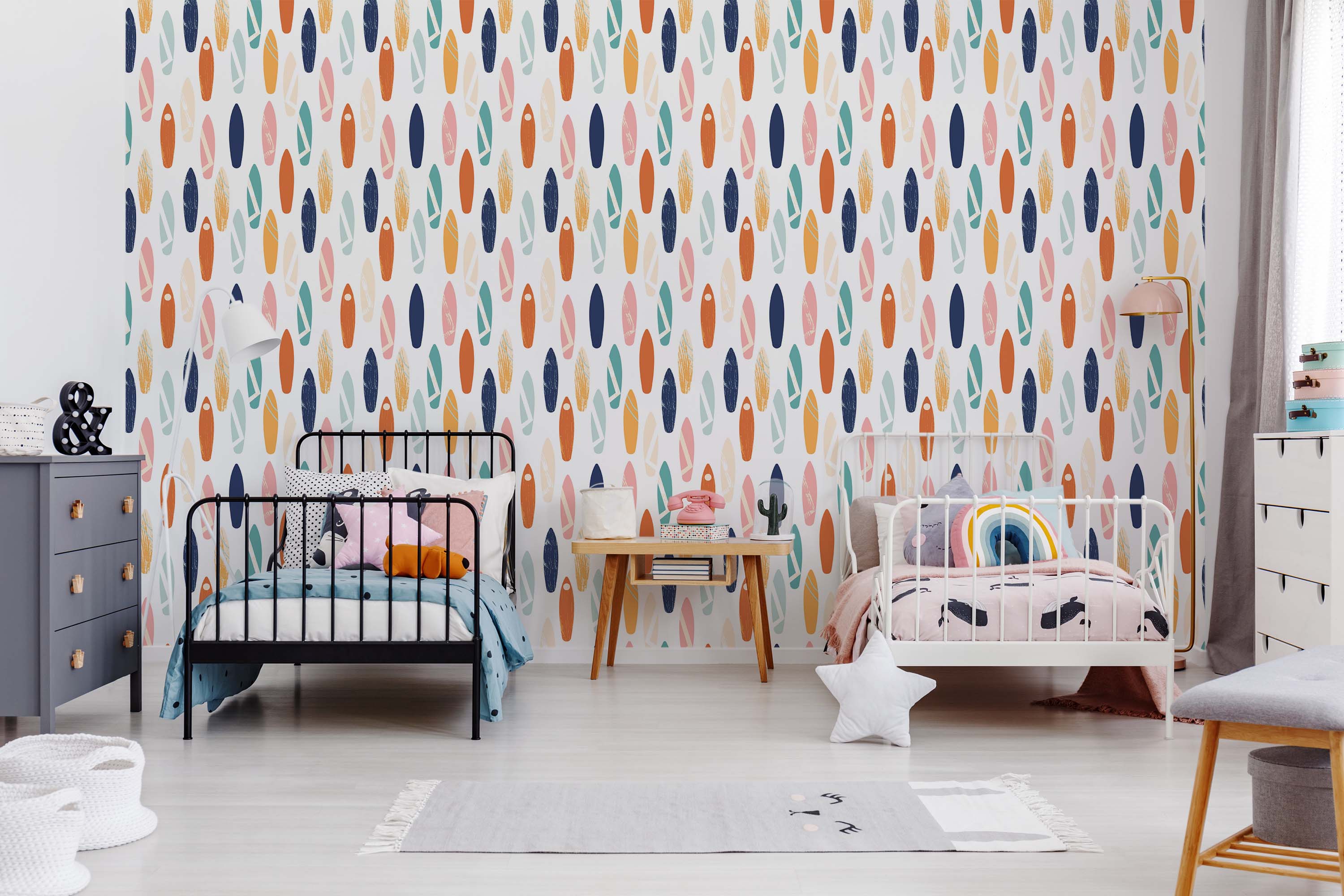 Wallpaper showcasing a repeating pattern of surfboards in a colorful mix of orange, navy blue, pink, teal, and pale yellow against a white field.