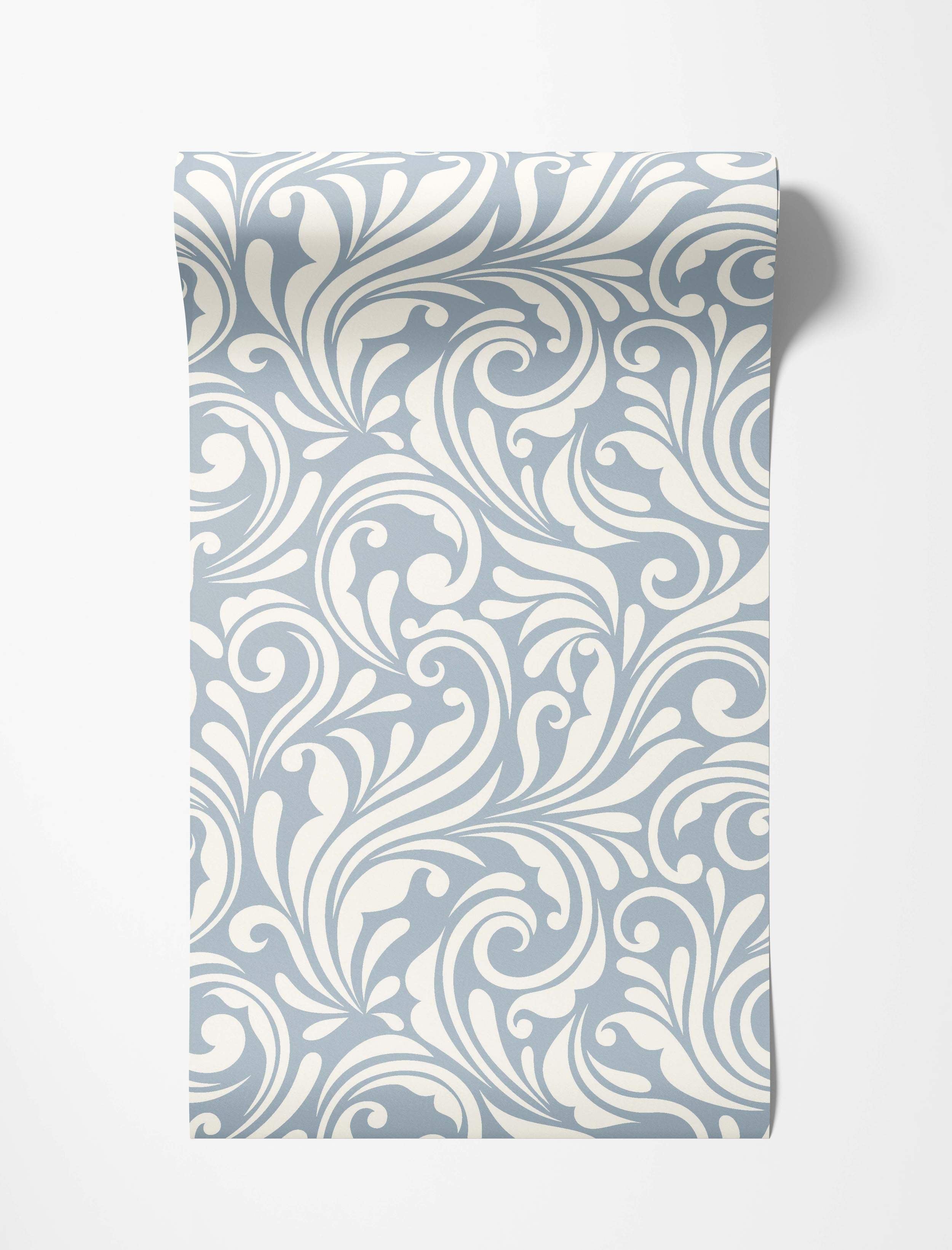 Wallpaper featuring a dense pattern of swirling cream scrolls and flourishes on a light blue background.
