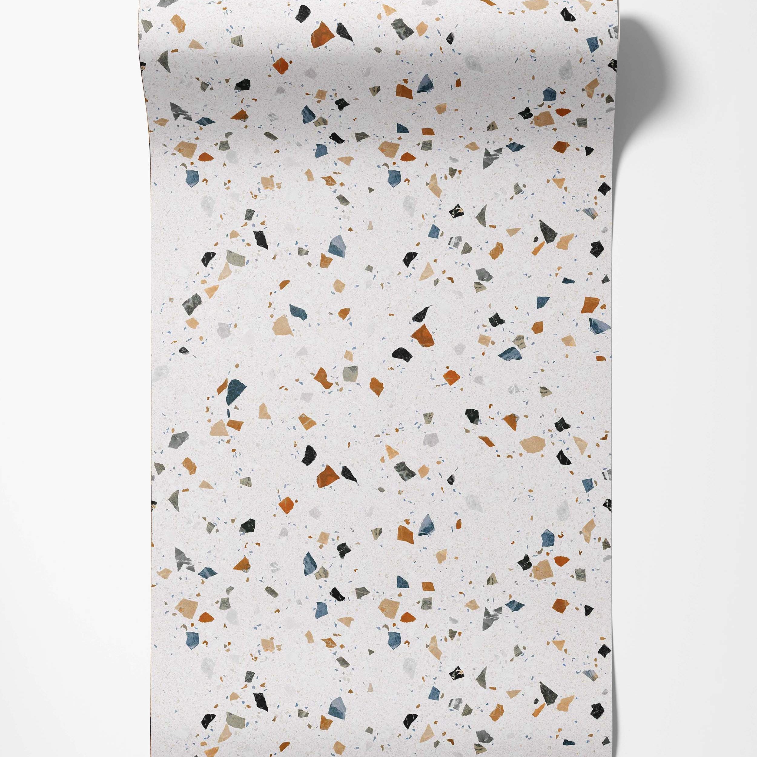 Wallpaper with a terrazzo pattern featuring blue, rust, beige, black, and gray chips on a light speckled background.