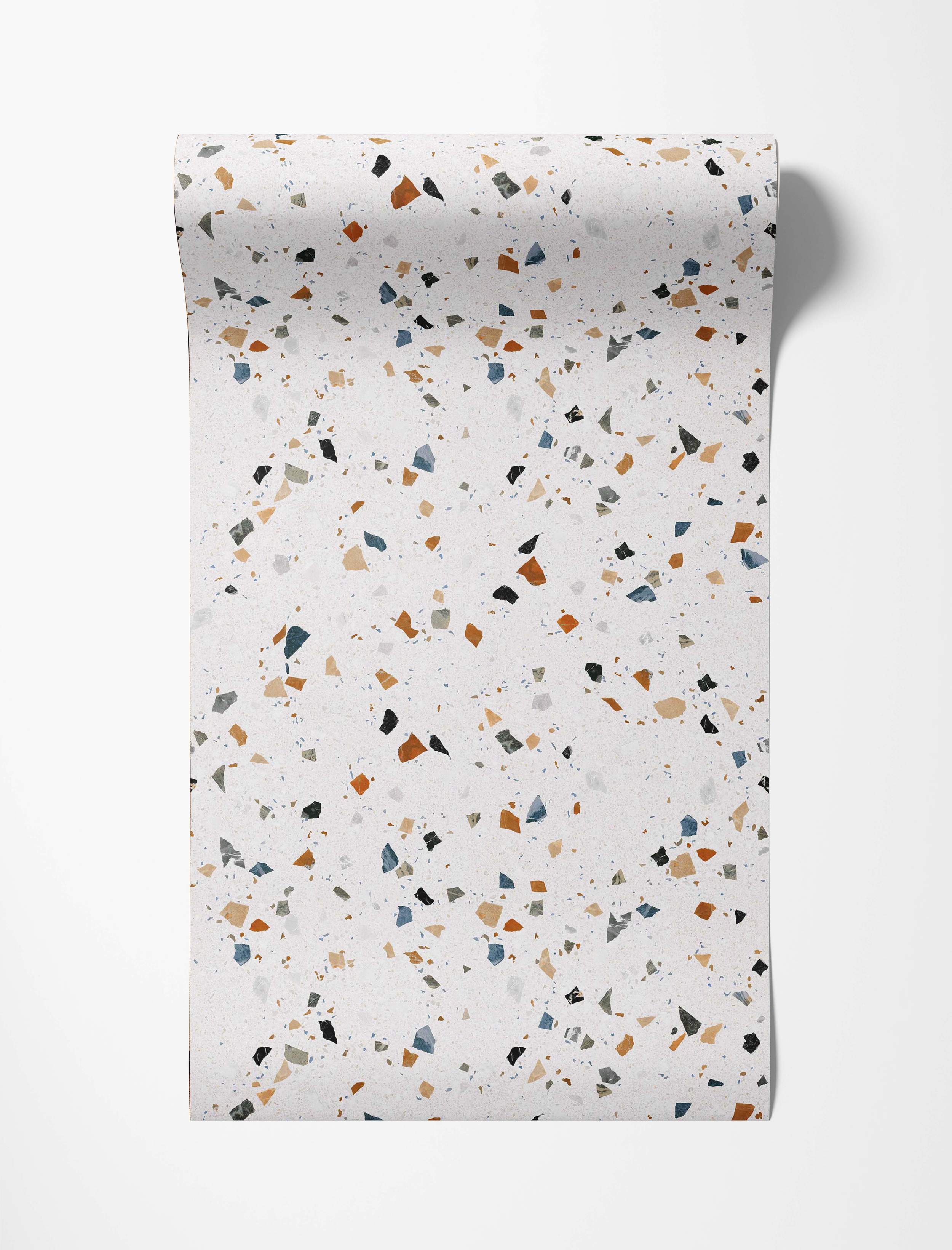 Wallpaper with a terrazzo pattern featuring blue, rust, beige, black, and gray chips on a light speckled background.