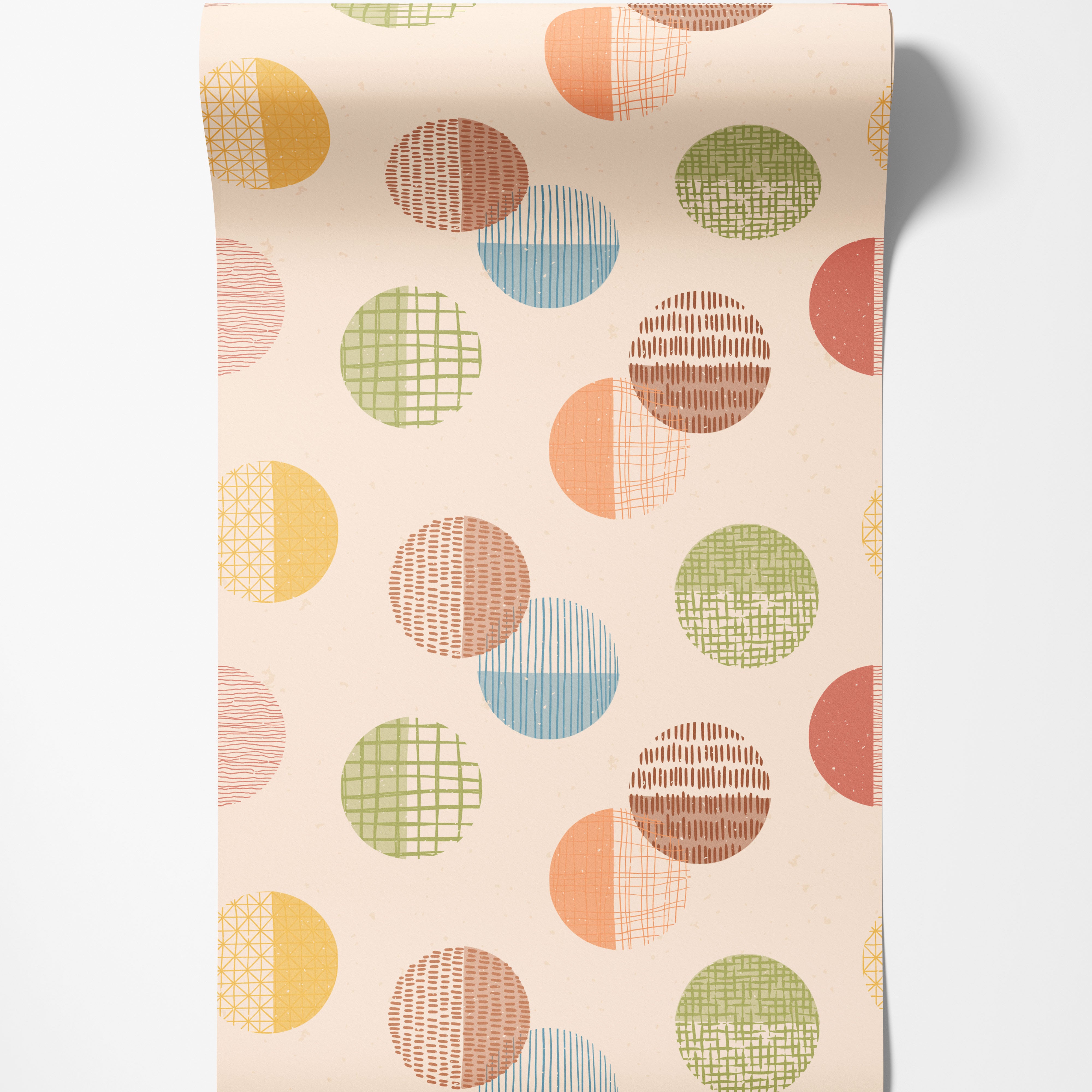 Wallpaper with a repeating pattern of textured circles in pastel yellow, orange, green, blue, and brown on a beige background.