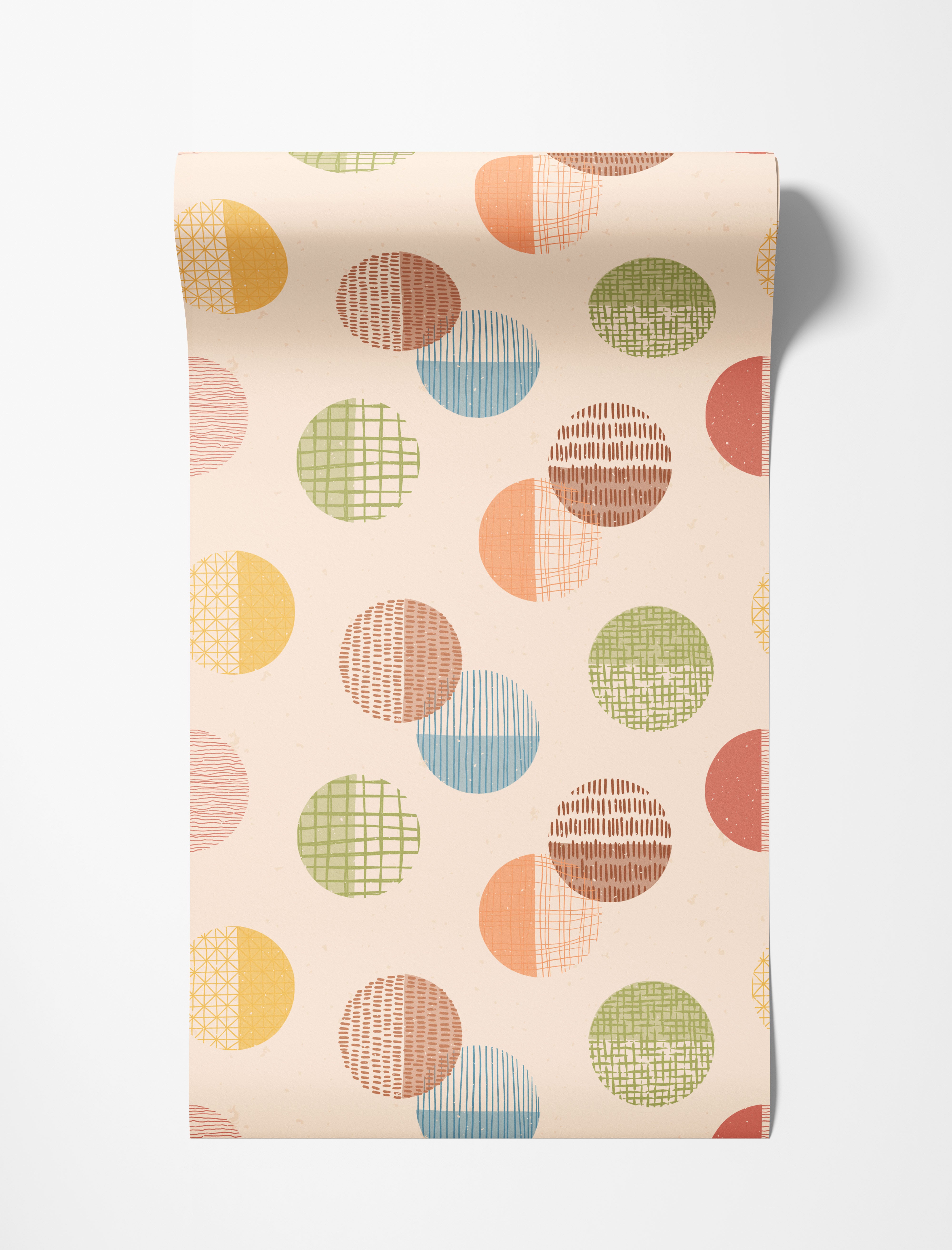 Wallpaper with a repeating pattern of textured circles in pastel yellow, orange, green, blue, and brown on a beige background.