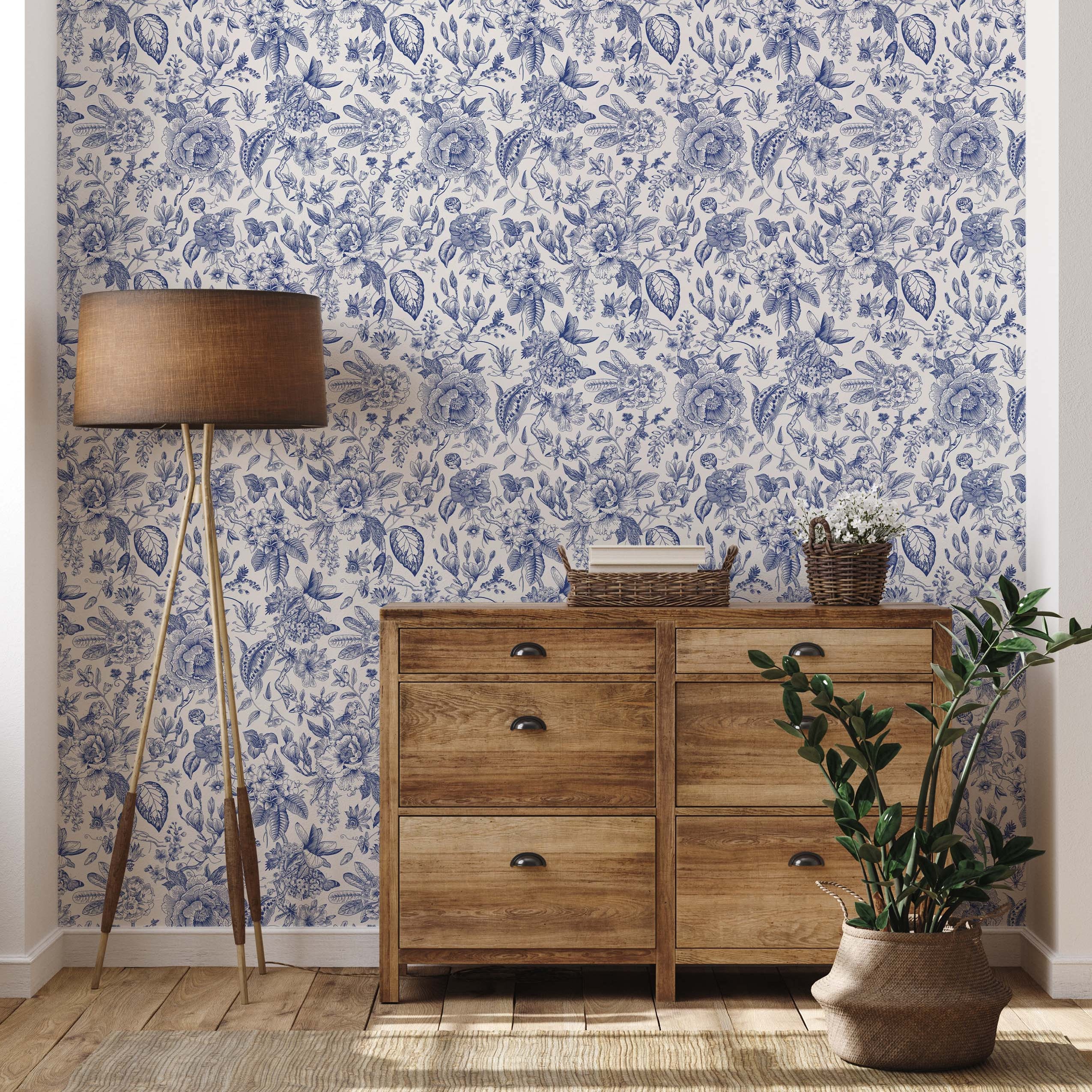 Intricate botanical wallpaper featuring detailed, hand-drawn style blue flowers and foliage on an off-white background.