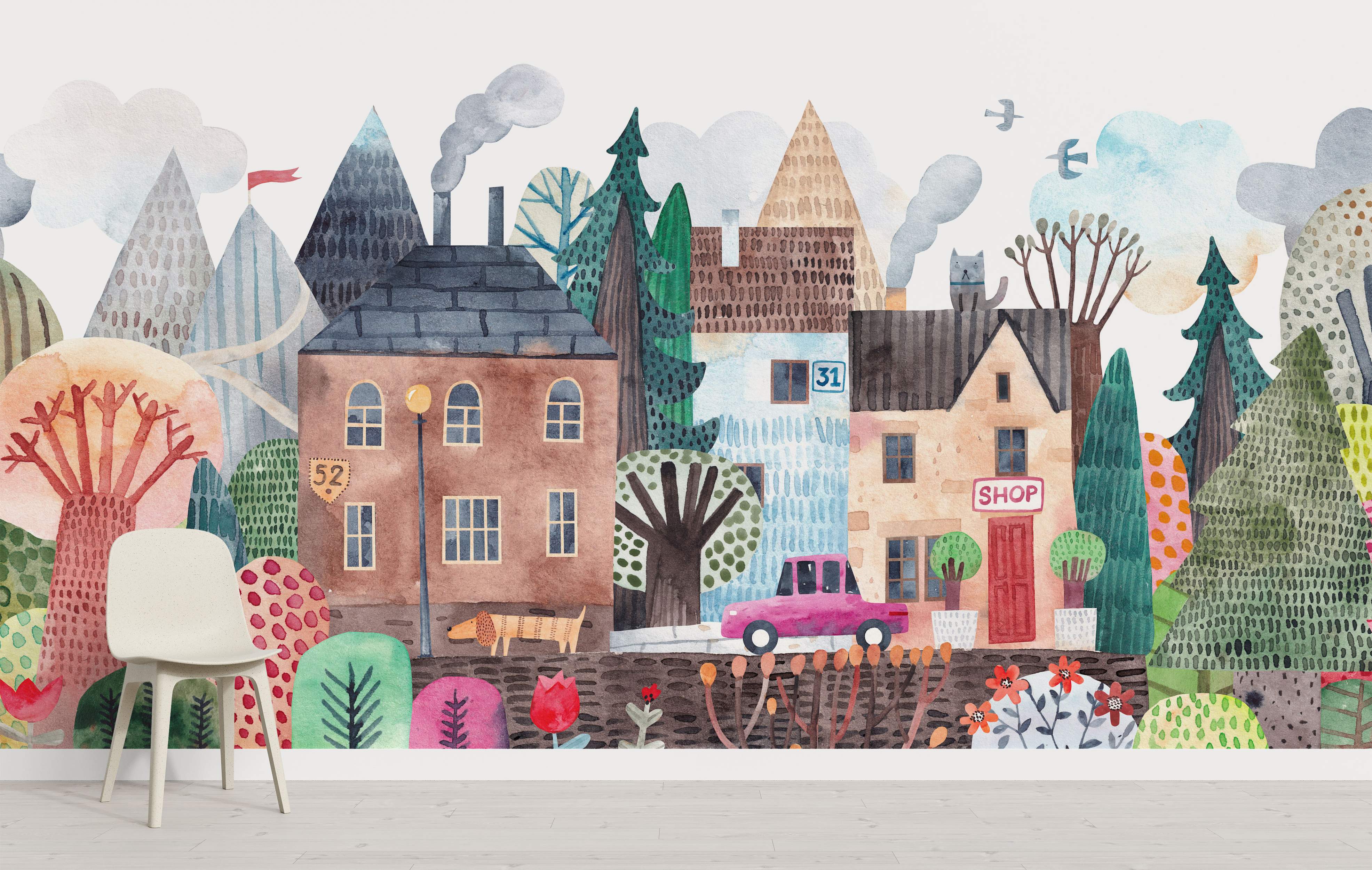 Whimsical watercolor town scene mural featuring colorful houses, stylized trees, mountains, and a car.