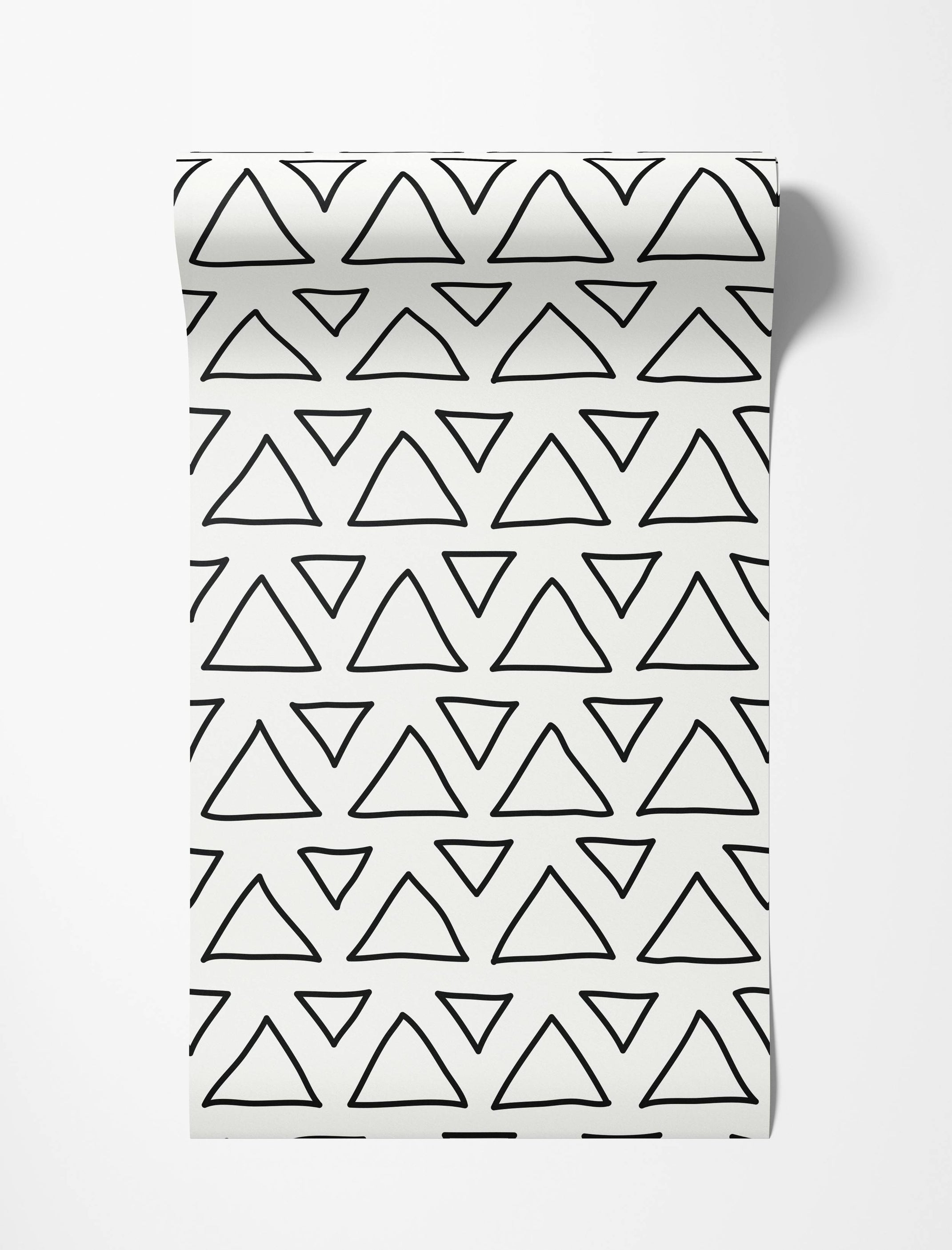 Wallpaper with a hand-drawn pattern of black outlined triangles arranged irregularly on a white background.