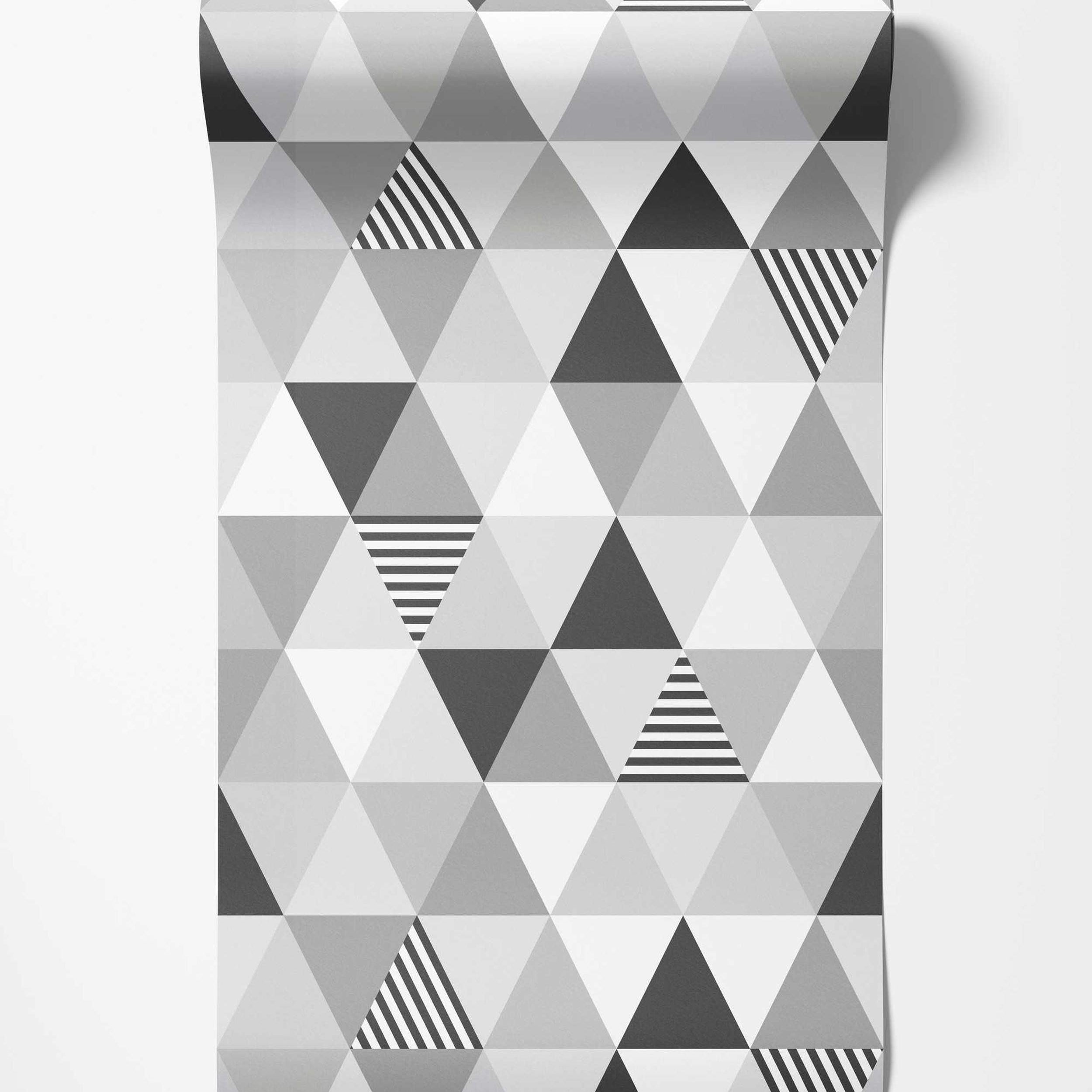 Geometric wallpaper featuring triangles in white, light gray, dark gray, and black and white stripes in a repeating pattern.