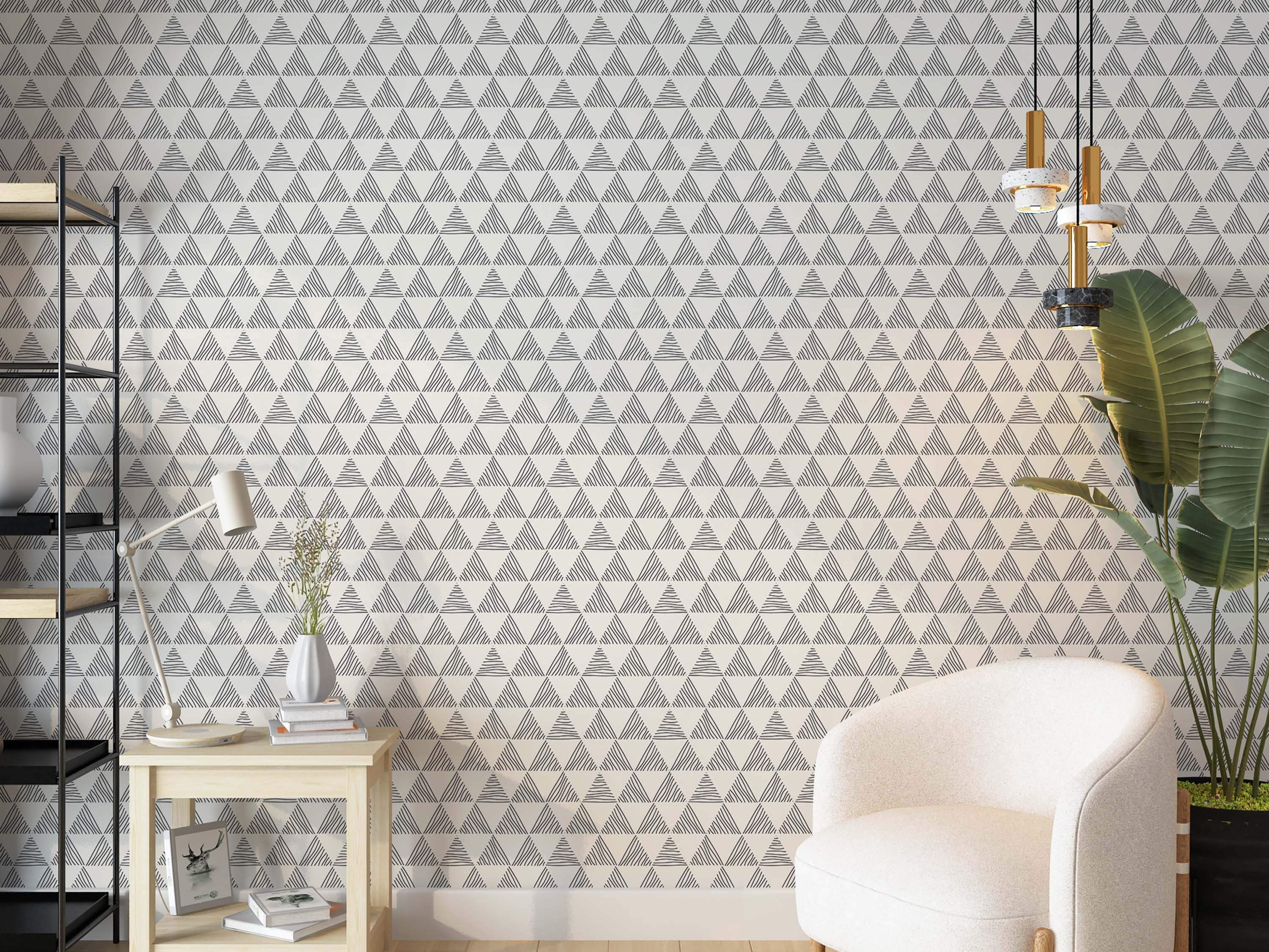 Geometric wallpaper featuring repeating hand-drawn triangles with internal line patterns in dark gray on an off-white background.