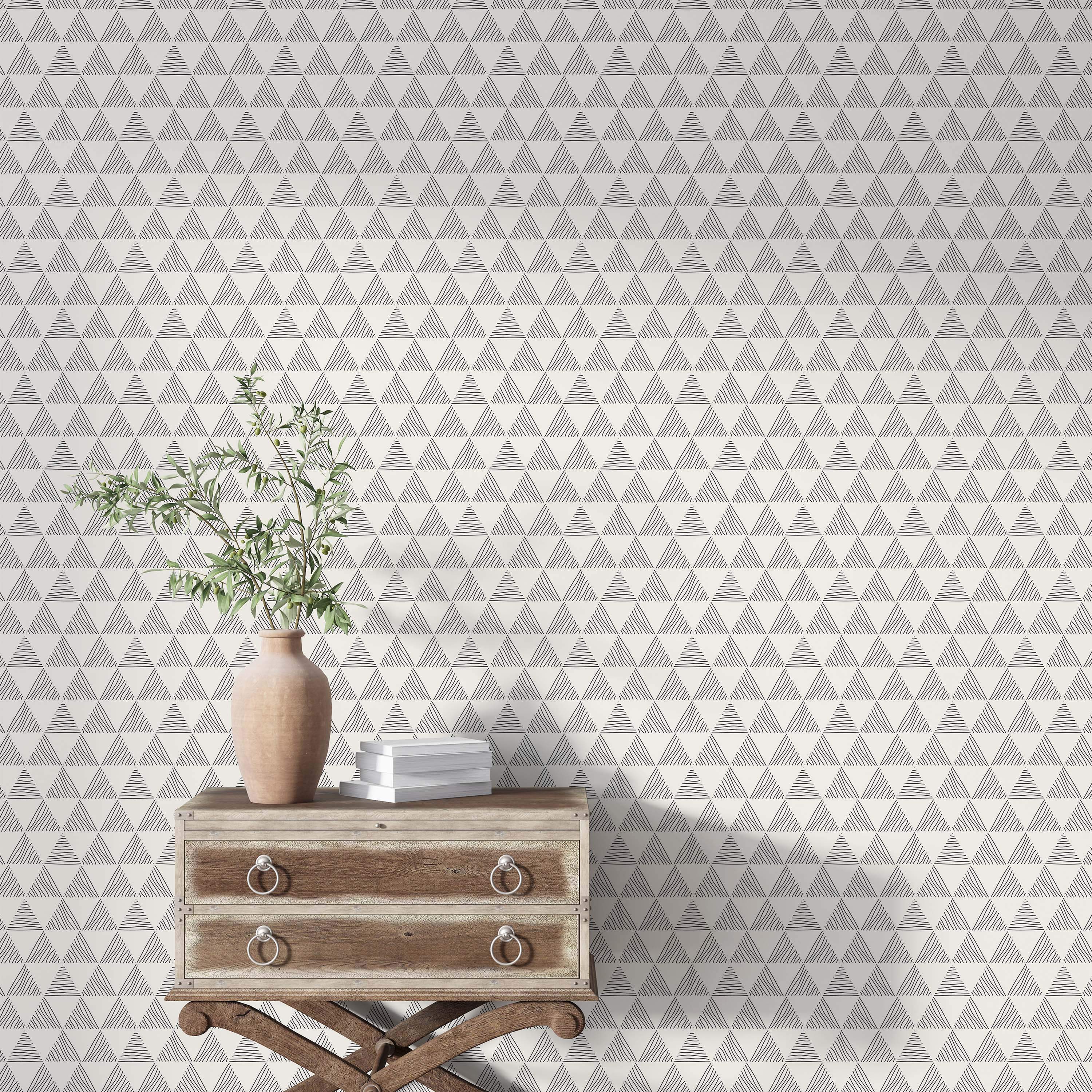 Wallpaper featuring a grid of hand-drawn triangles filled with varied black sketch lines on a light off-white background.