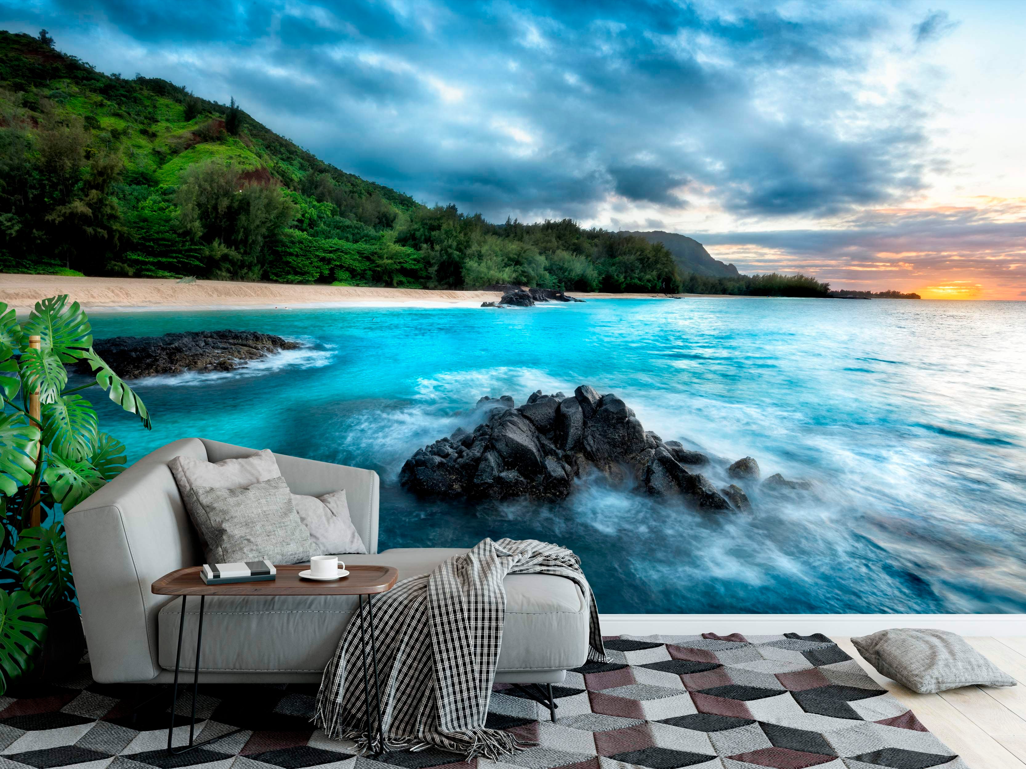 Mural depicting a tropical beach scene with turquoise water crashing on rocks, green hills, and a vibrant sunset sky.