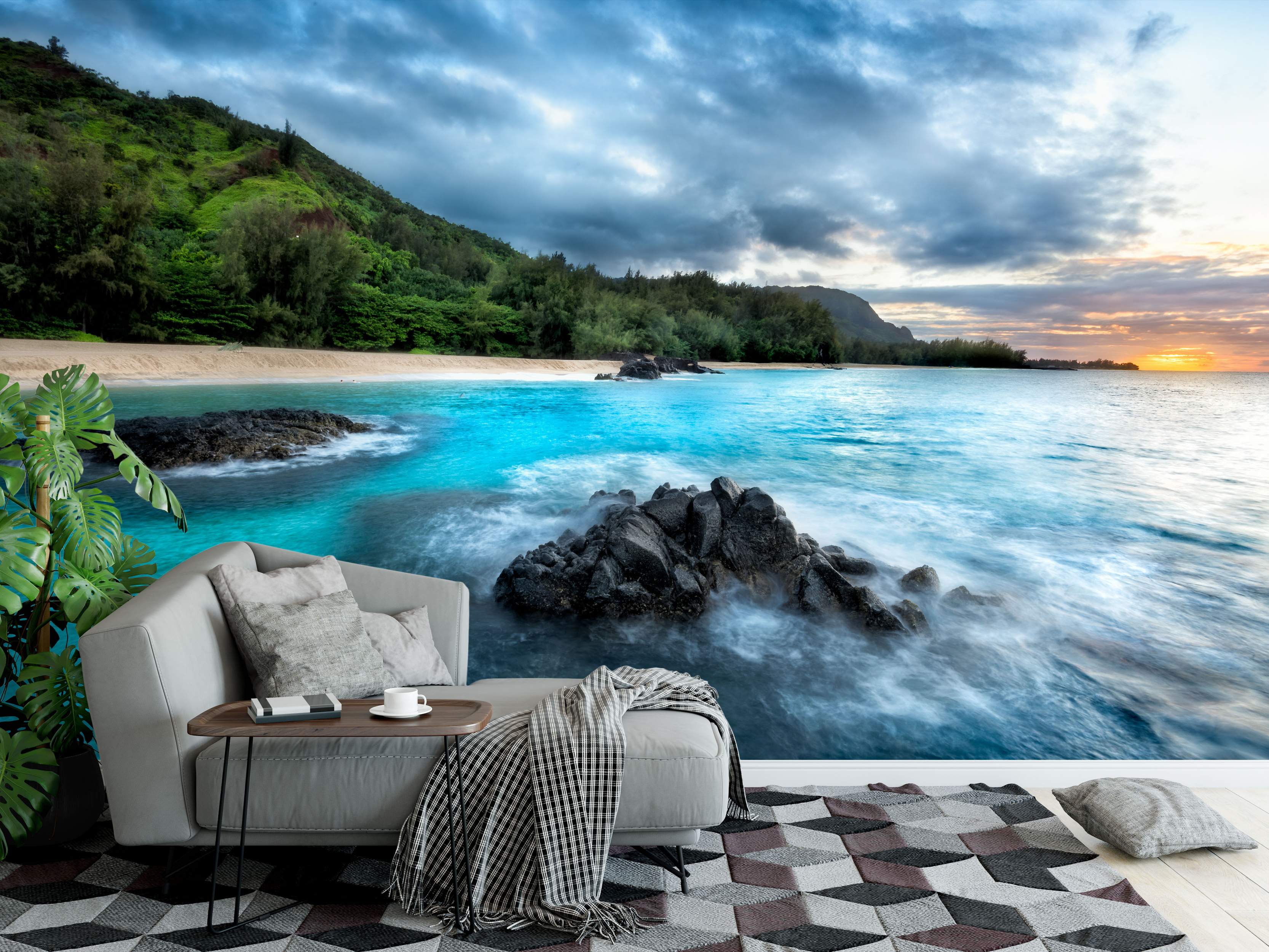 Mural depicting a tropical beach scene with turquoise water crashing on rocks, green hills, and a vibrant sunset sky.