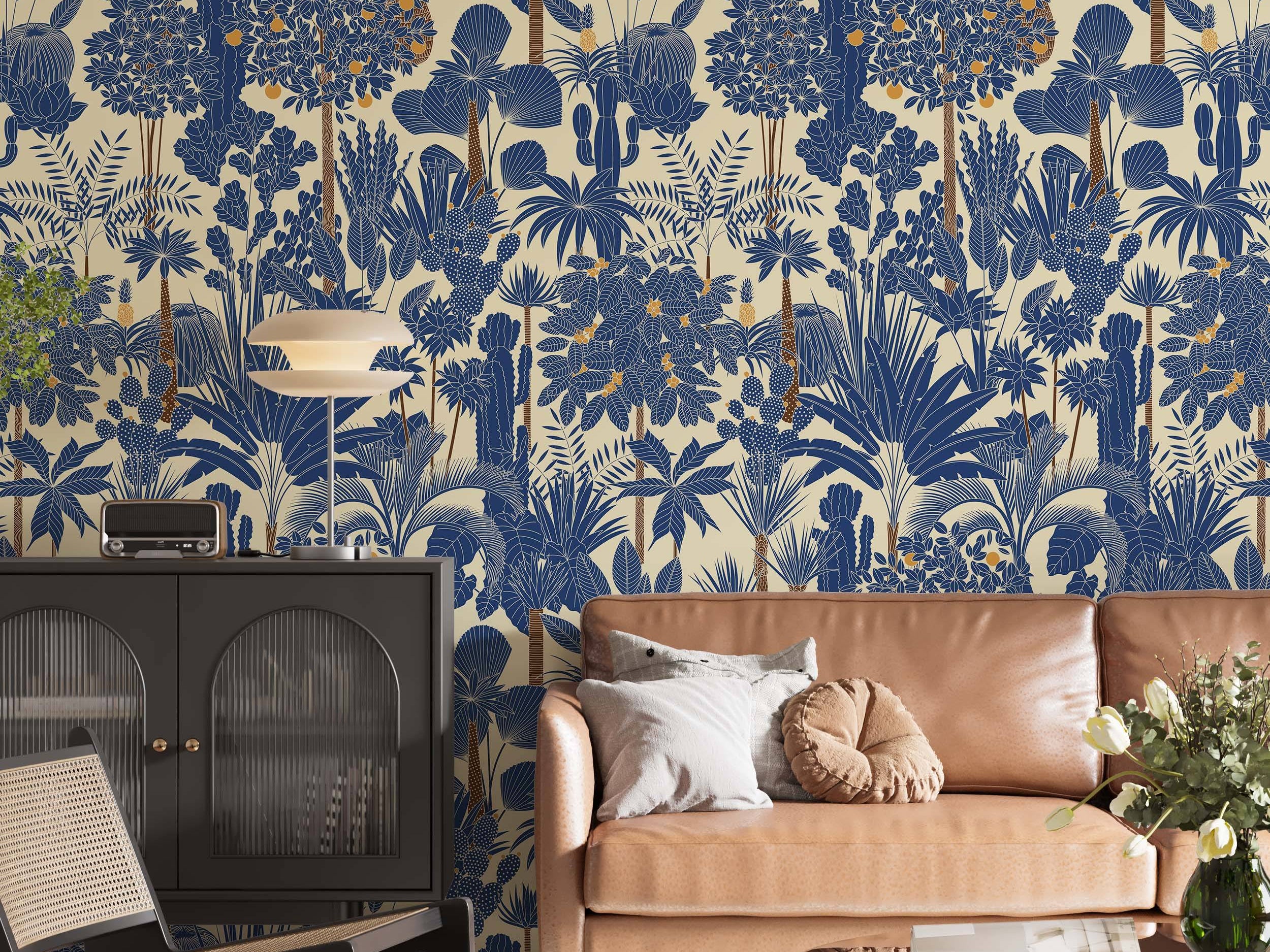 Stylized tropical botanical wallpaper featuring blue palm trees, cacti, and plants with orange fruits on a light beige background.