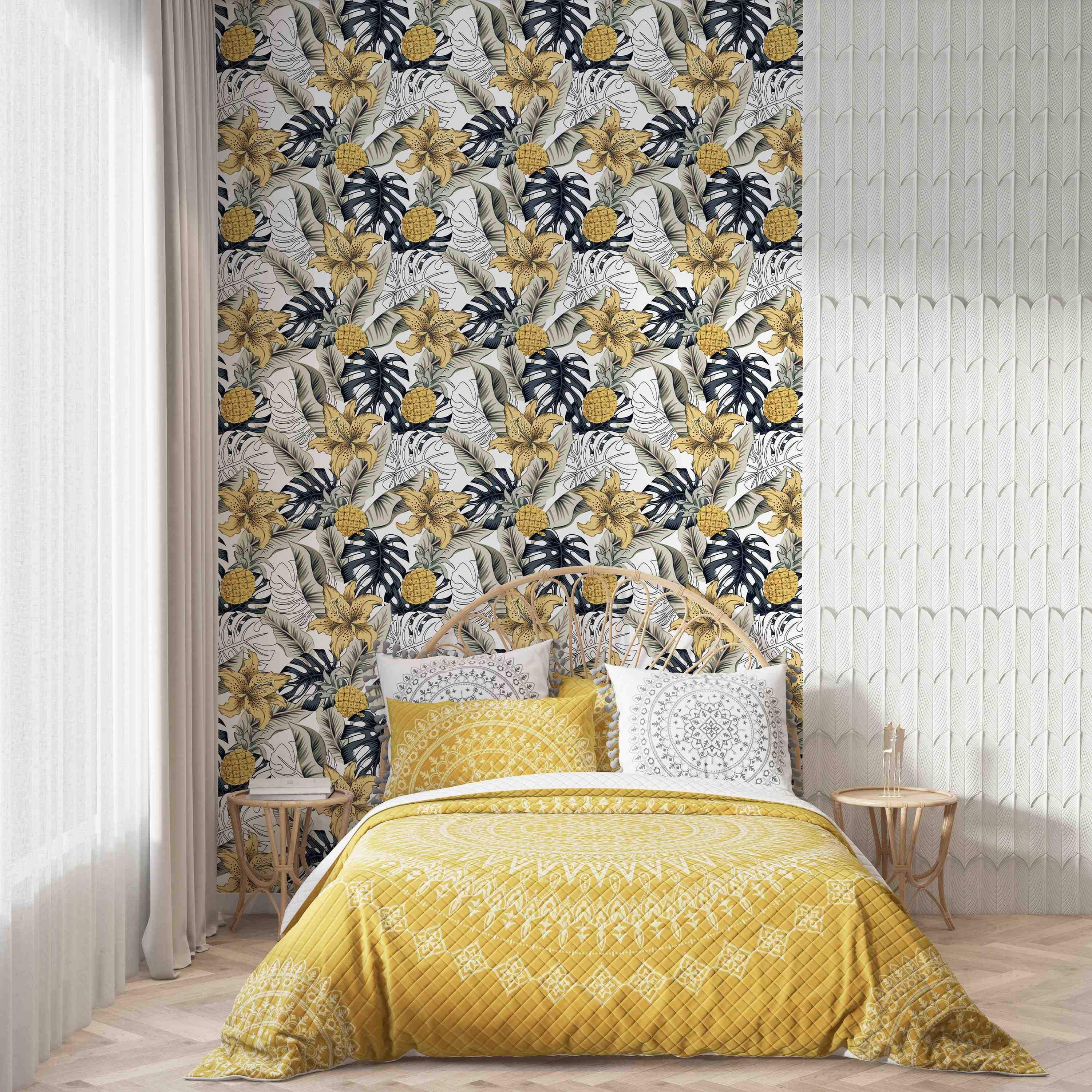 Tropical wallpaper featuring yellow lilies, pineapples, dark blue and sketched monstera leaves, and tan leaves on white.