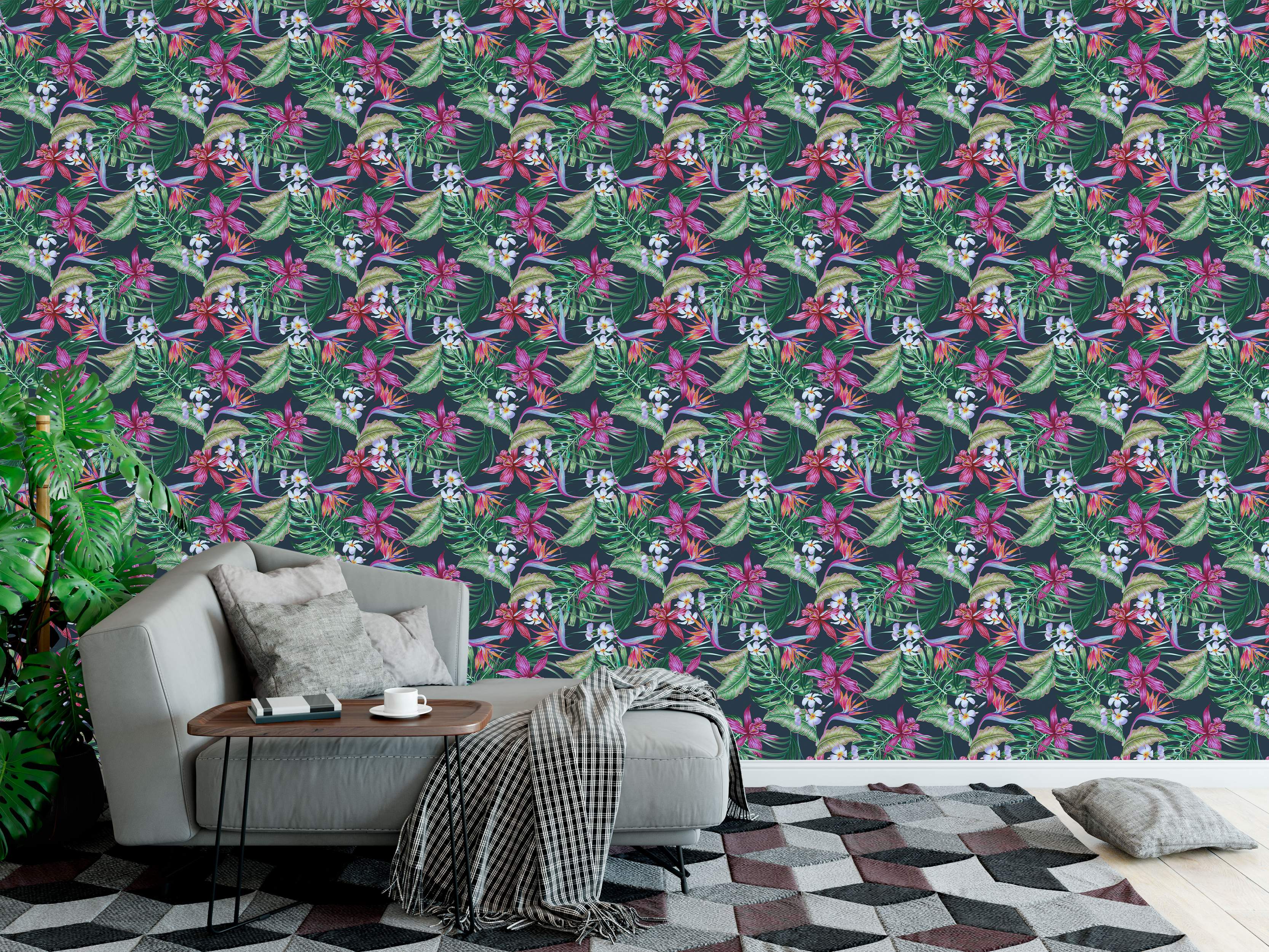 Wallpaper with a repeating tropical pattern featuring pink orchids, white plumeria, orange birds of paradise, and green leaves on a dark background.