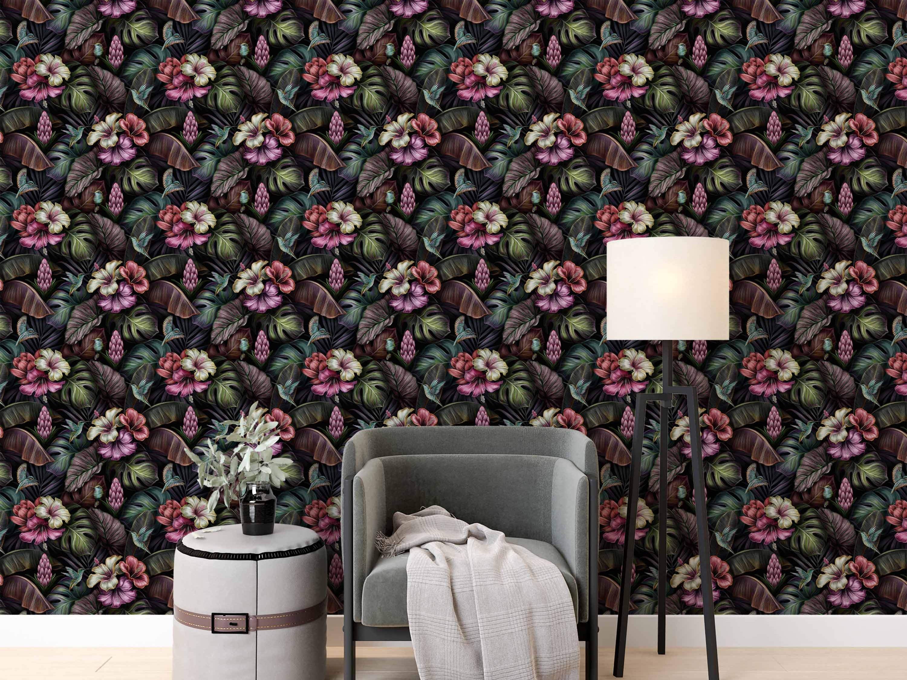 Dark tropical wallpaper featuring detailed pink hibiscus, lush green and purple leaves, ginger flowers, and small hummingbirds.