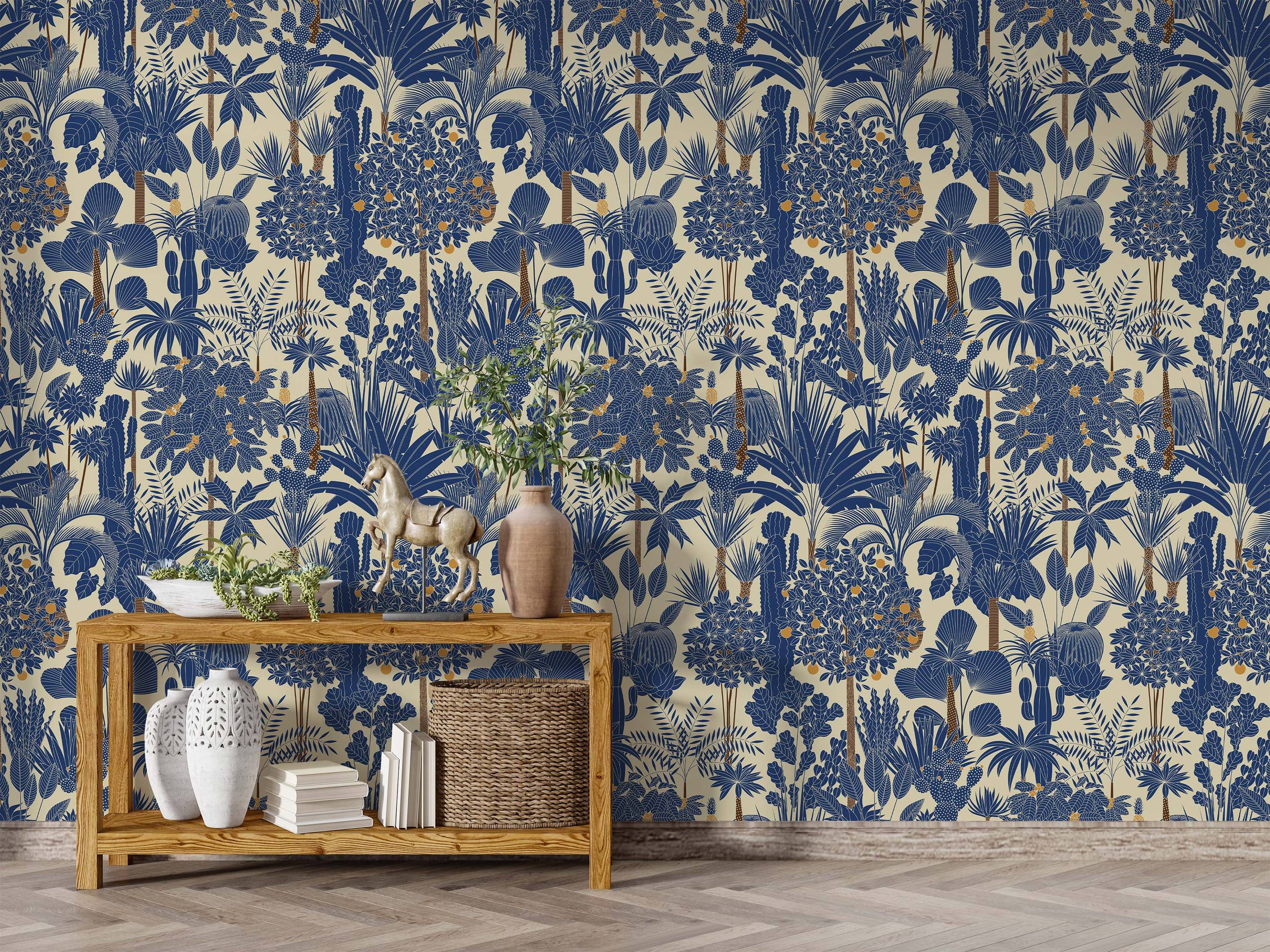 Blue and cream tropical jungle wallpaper featuring stylized plants, palm trees, and orange fruit accents.