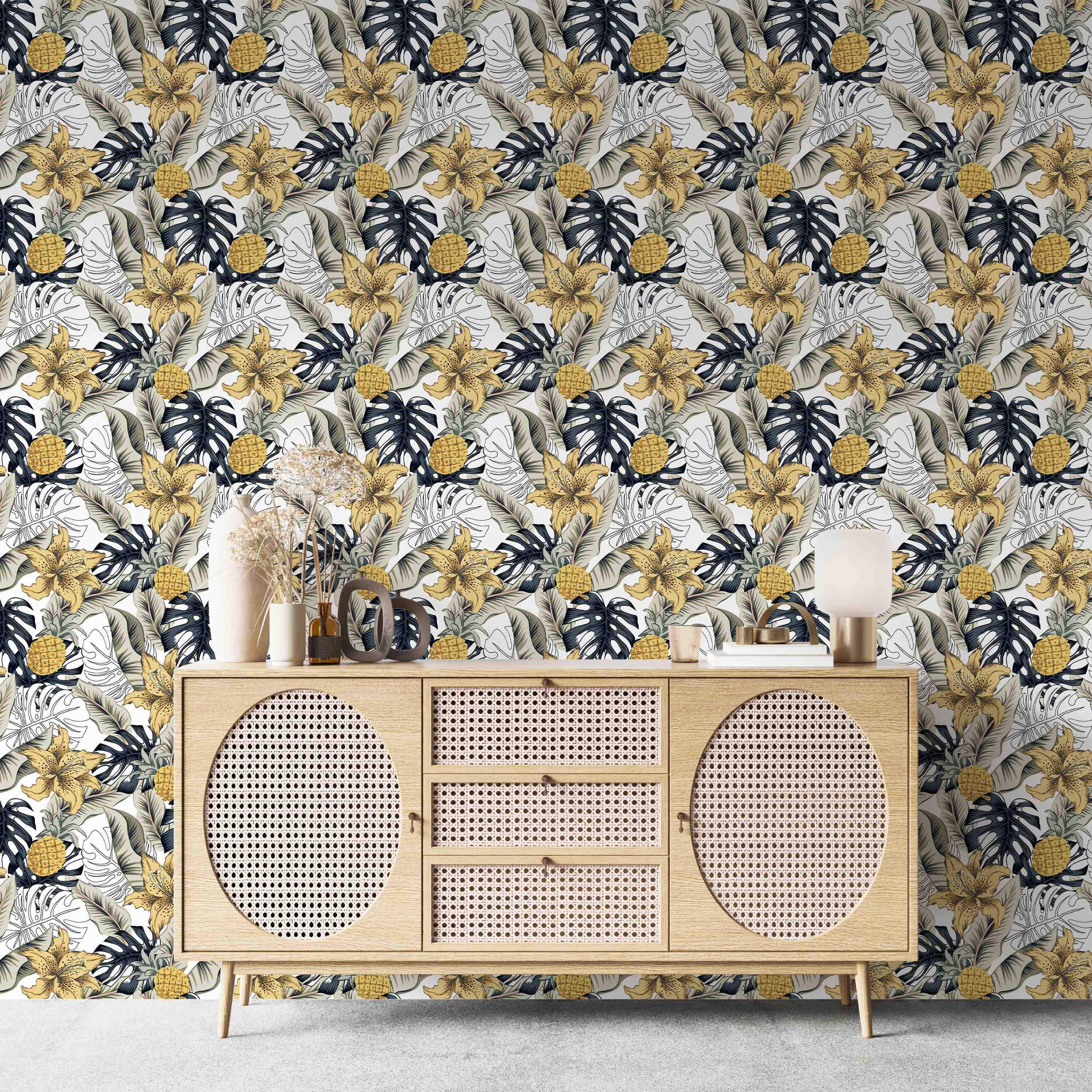 Tropical wallpaper featuring yellow lilies, pineapples, dark blue Monstera, and beige banana leaves on a white background.