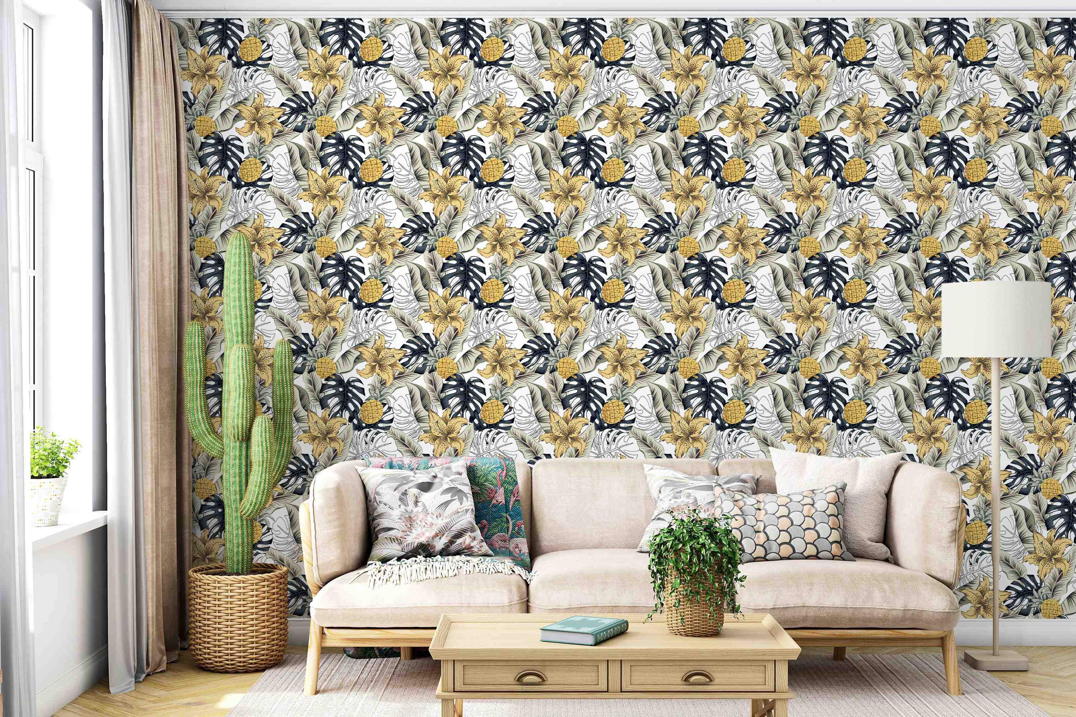 Tropical wallpaper pattern with yellow lilies, pineapples, dark grey, muted green, and outlined leaves on a white background.