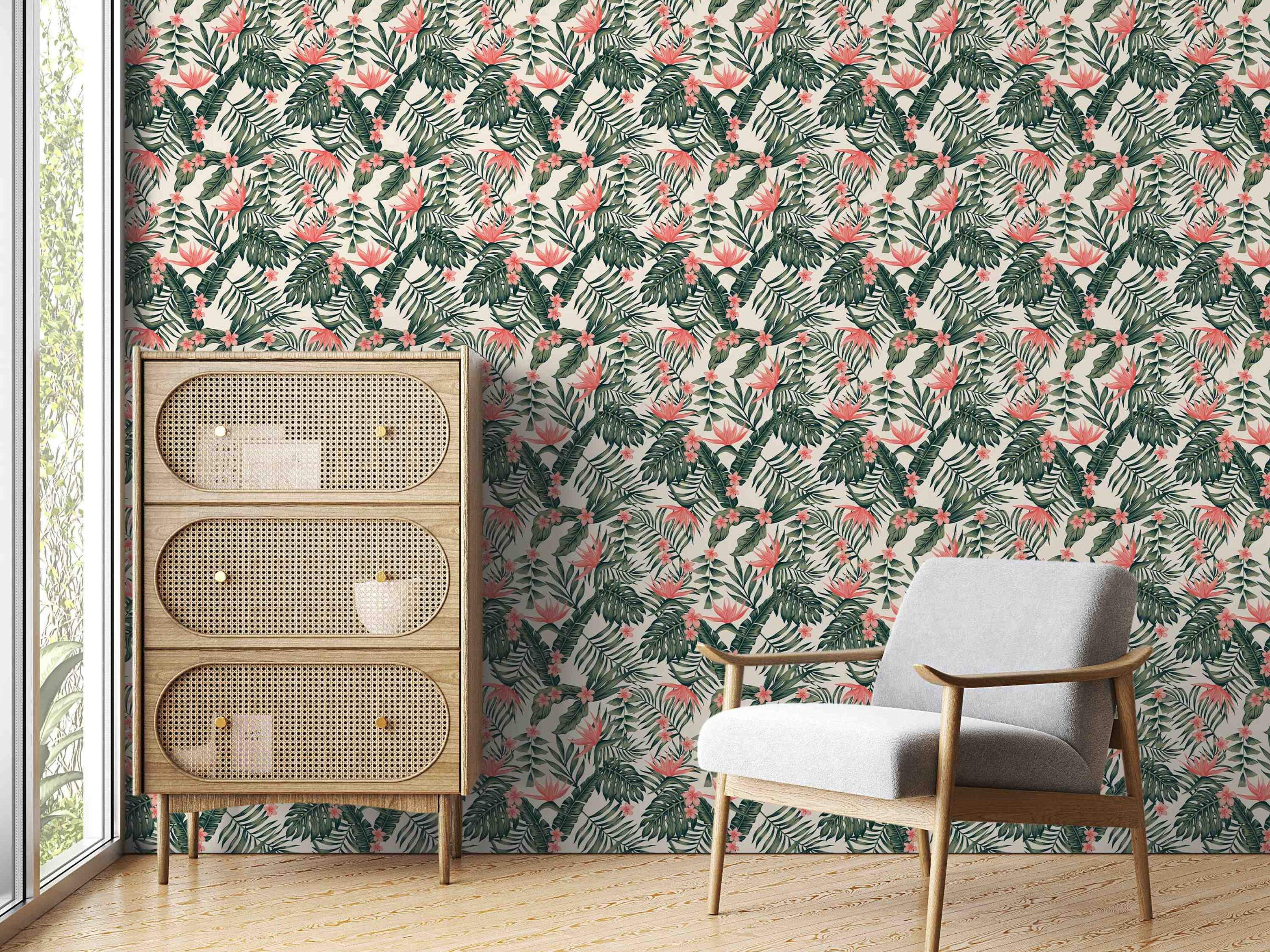 Wallpaper featuring a repeating tropical pattern of assorted green leaves and pink/coral flowers on a light cream background.