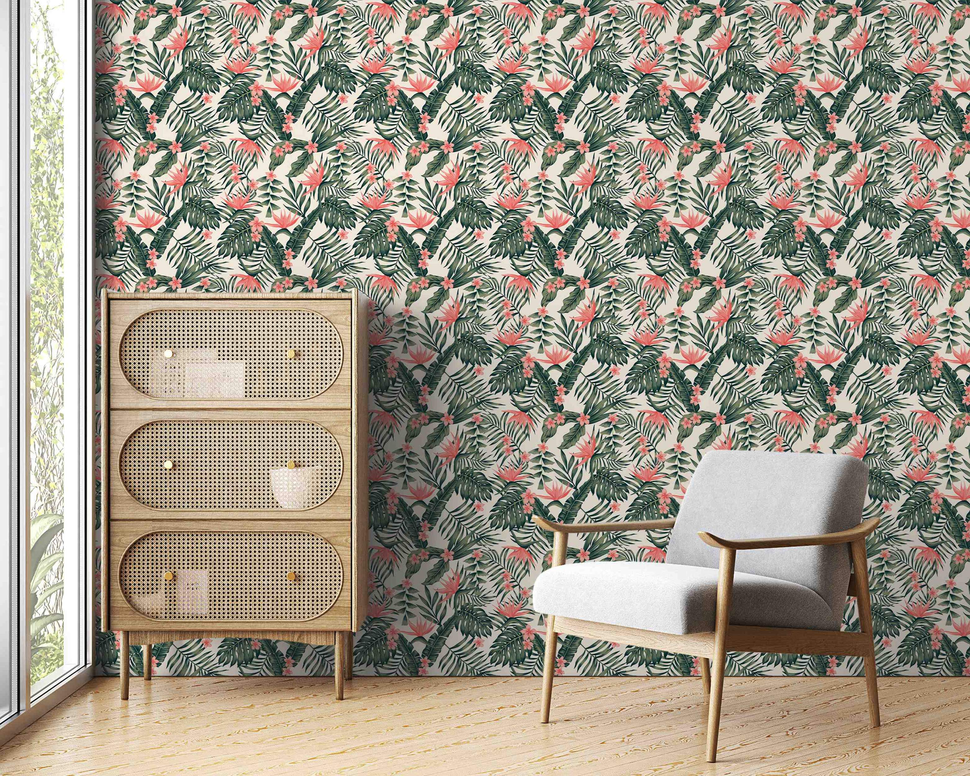 Wallpaper featuring a repeating tropical pattern of assorted green leaves and pink/coral flowers on a light cream background.