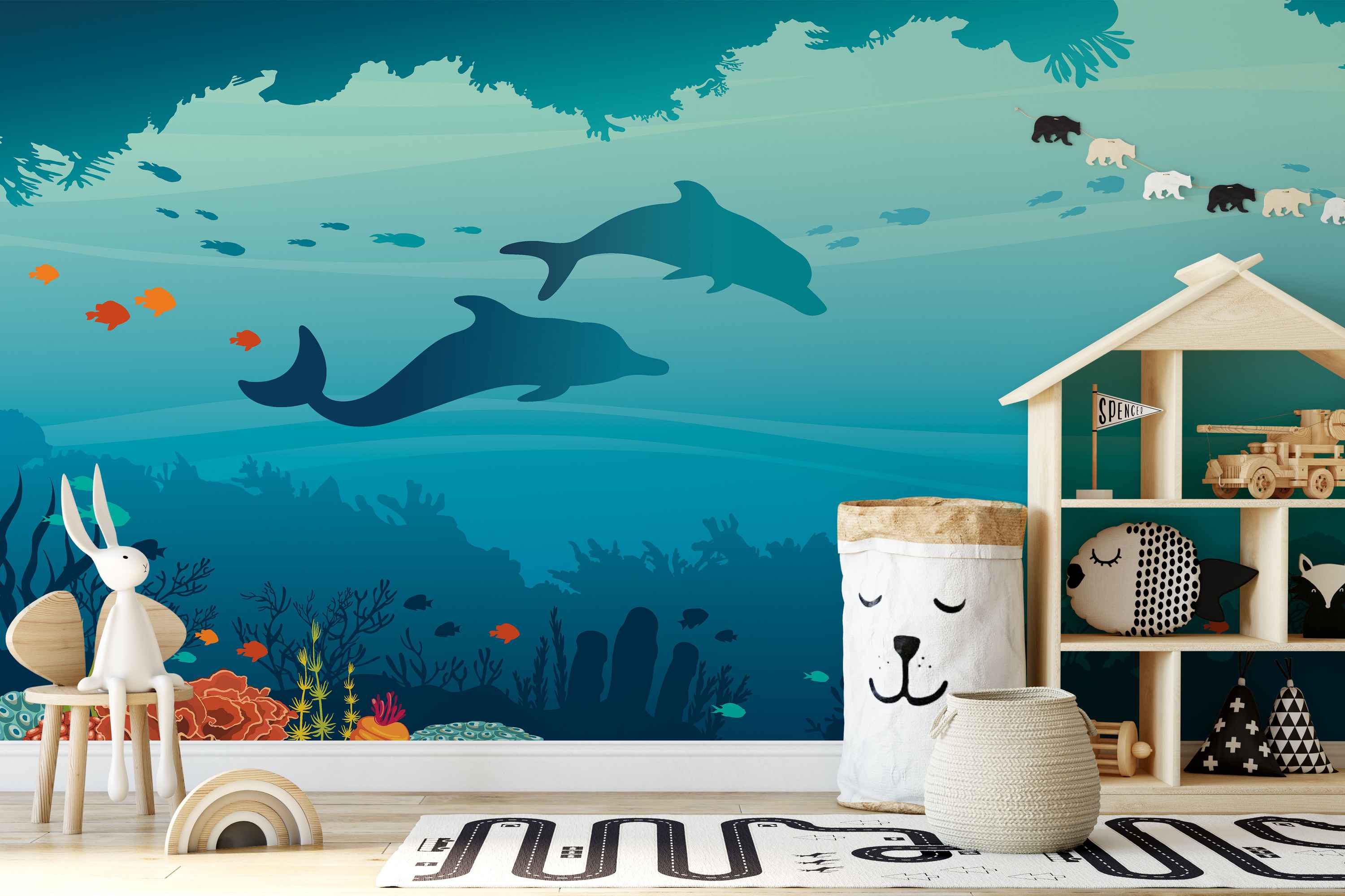 Blue and teal underwater mural with silhouettes of dolphins, fish, coral, seaweed, and a string of bears.