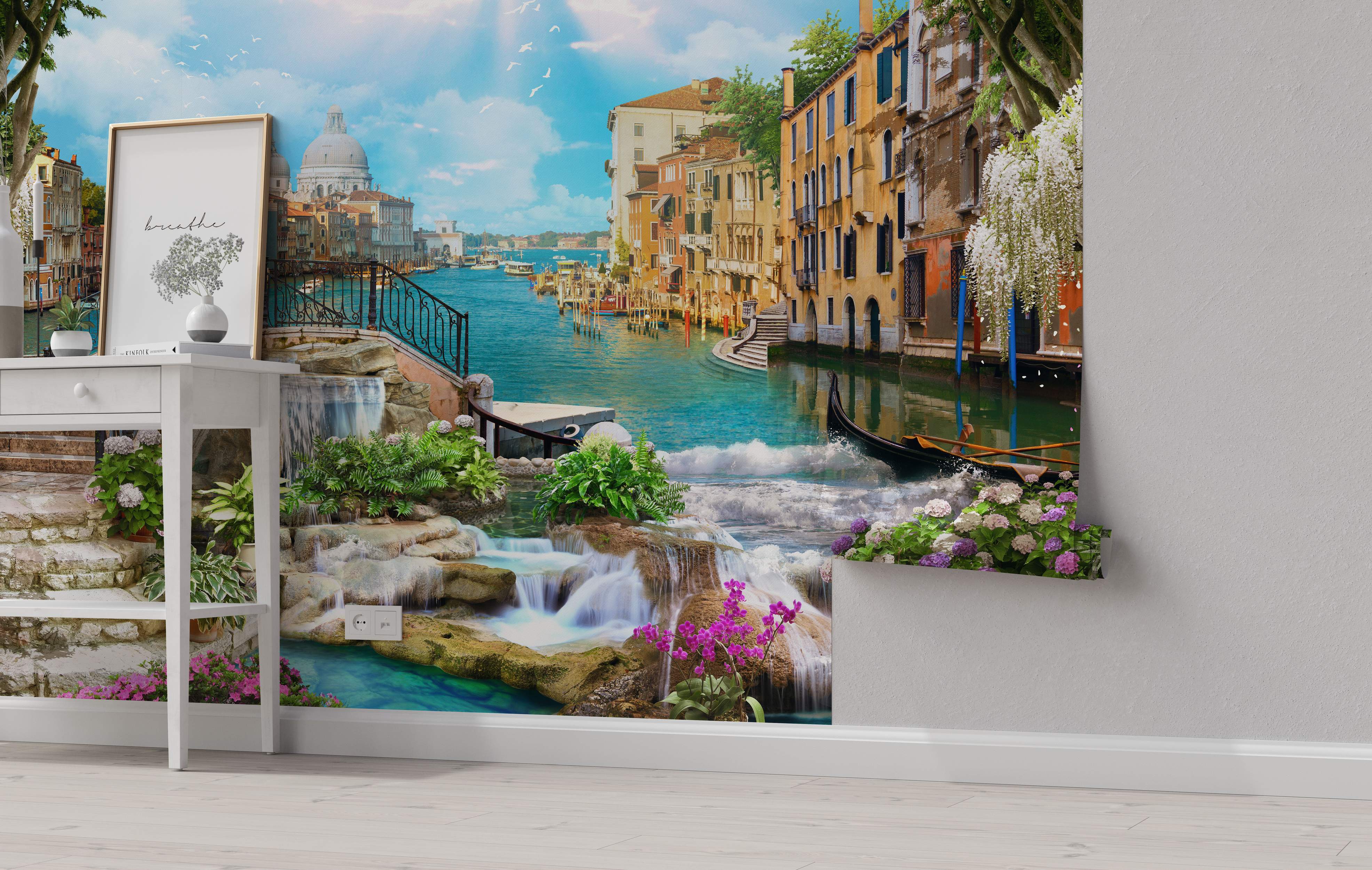 Photorealistic mural combining a Venice canal scene with blue water, colorful buildings under a blue sky, and foreground waterfalls with rocks and flowers.