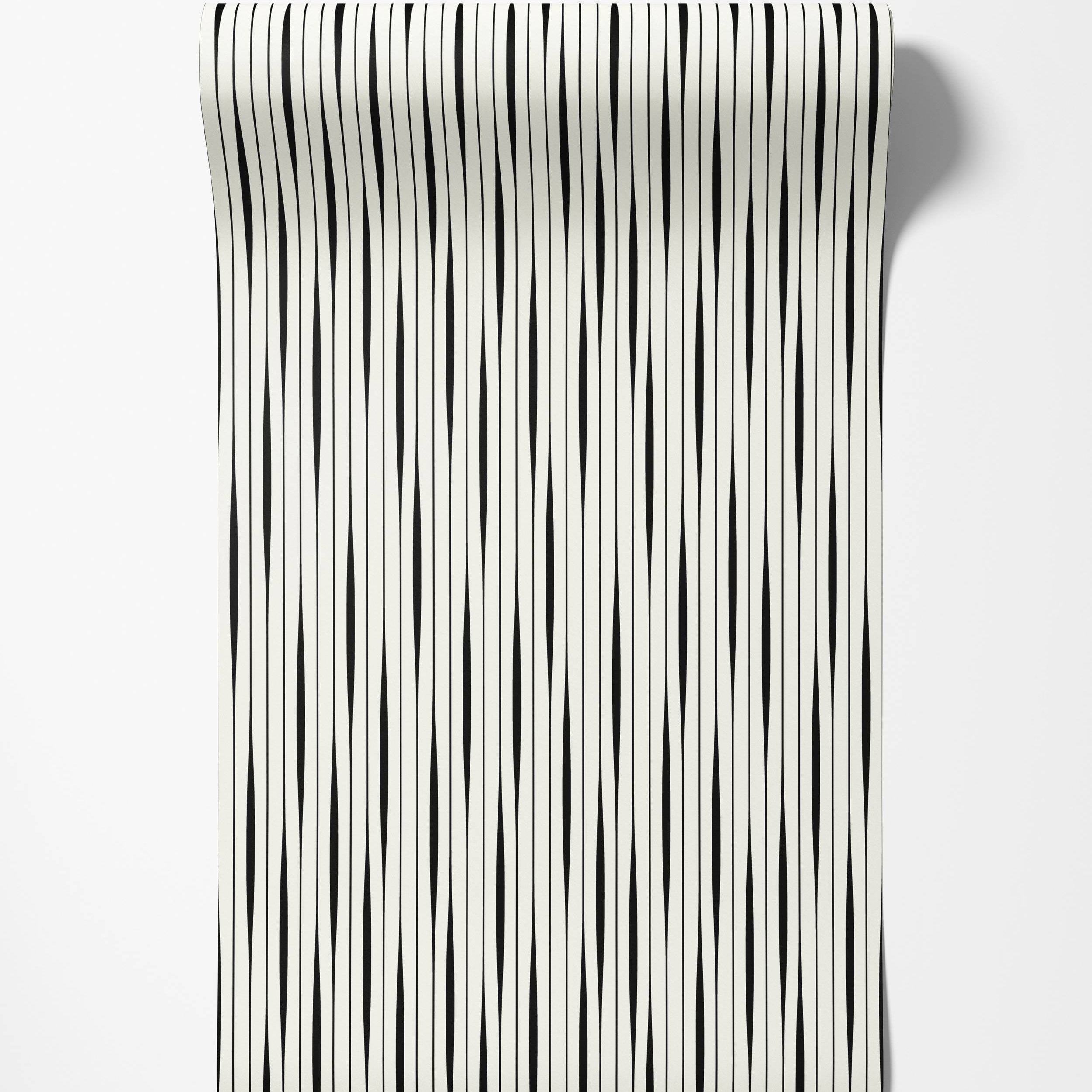 Wallpaper featuring vertical black stripes with a subtle taper on an off-white background.