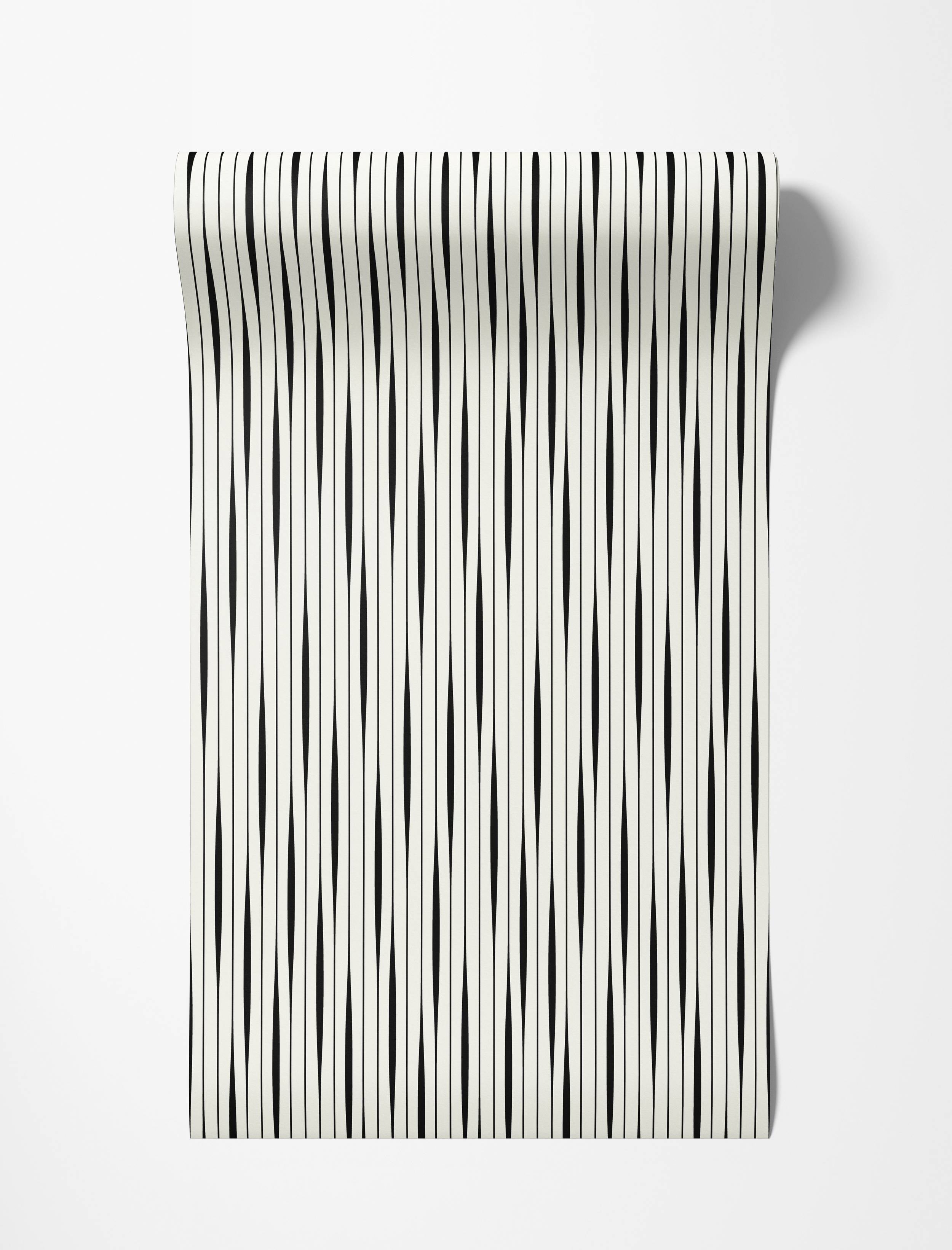 Wallpaper featuring vertical black stripes with a subtle taper on an off-white background.