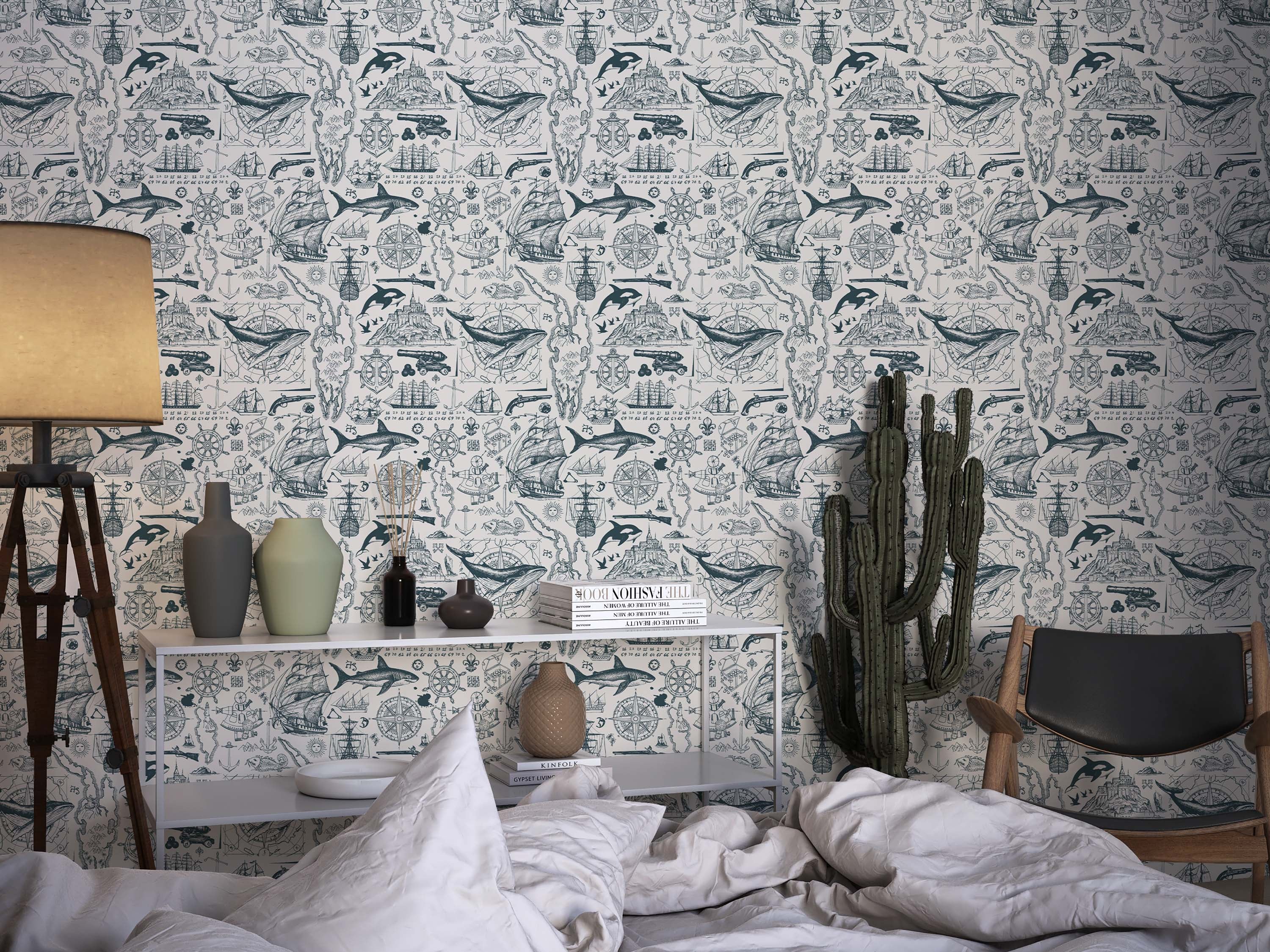 Wallpaper featuring a repeating pattern of vintage nautical sketches in teal on a cream background, depicting ships, whales, and maps.