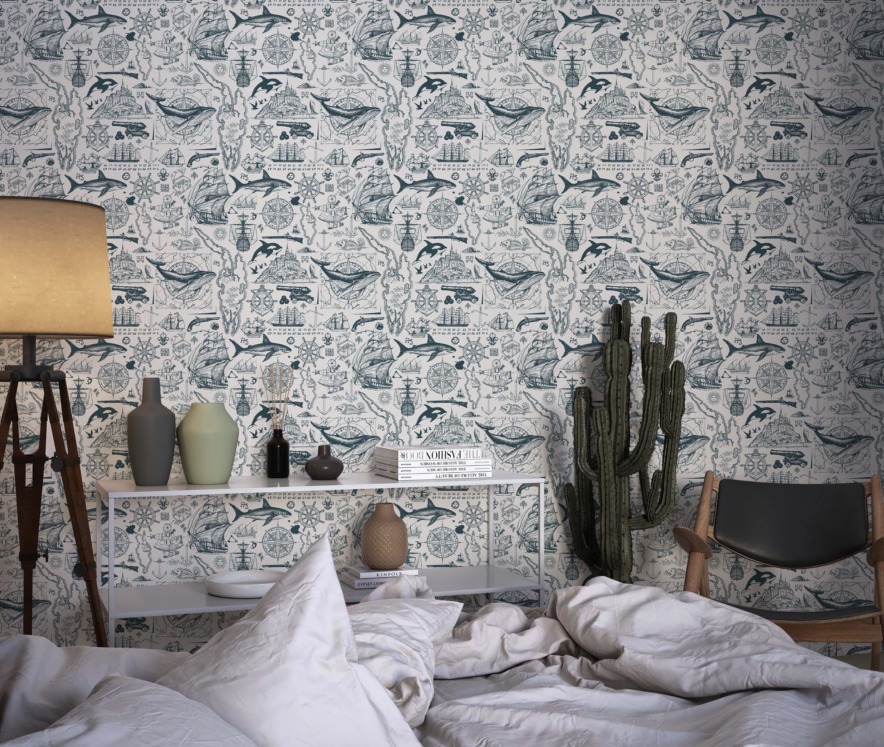Wallpaper featuring a repeating pattern of vintage nautical sketches in teal on a cream background, depicting ships, whales, and maps.