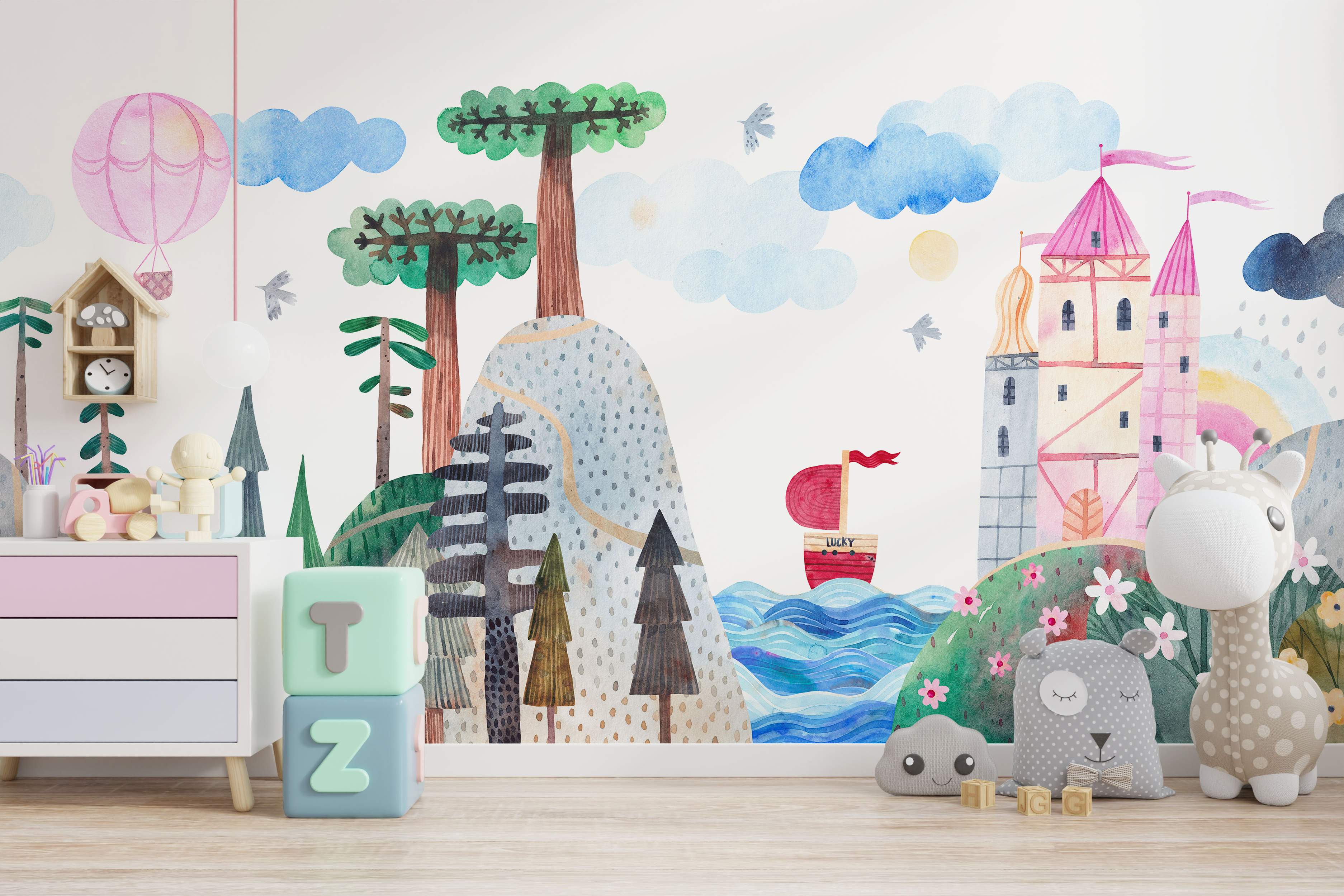 Watercolor mural depicting a whimsical landscape with a pink castle, trees, blue clouds, a hot air balloon, and a boat.