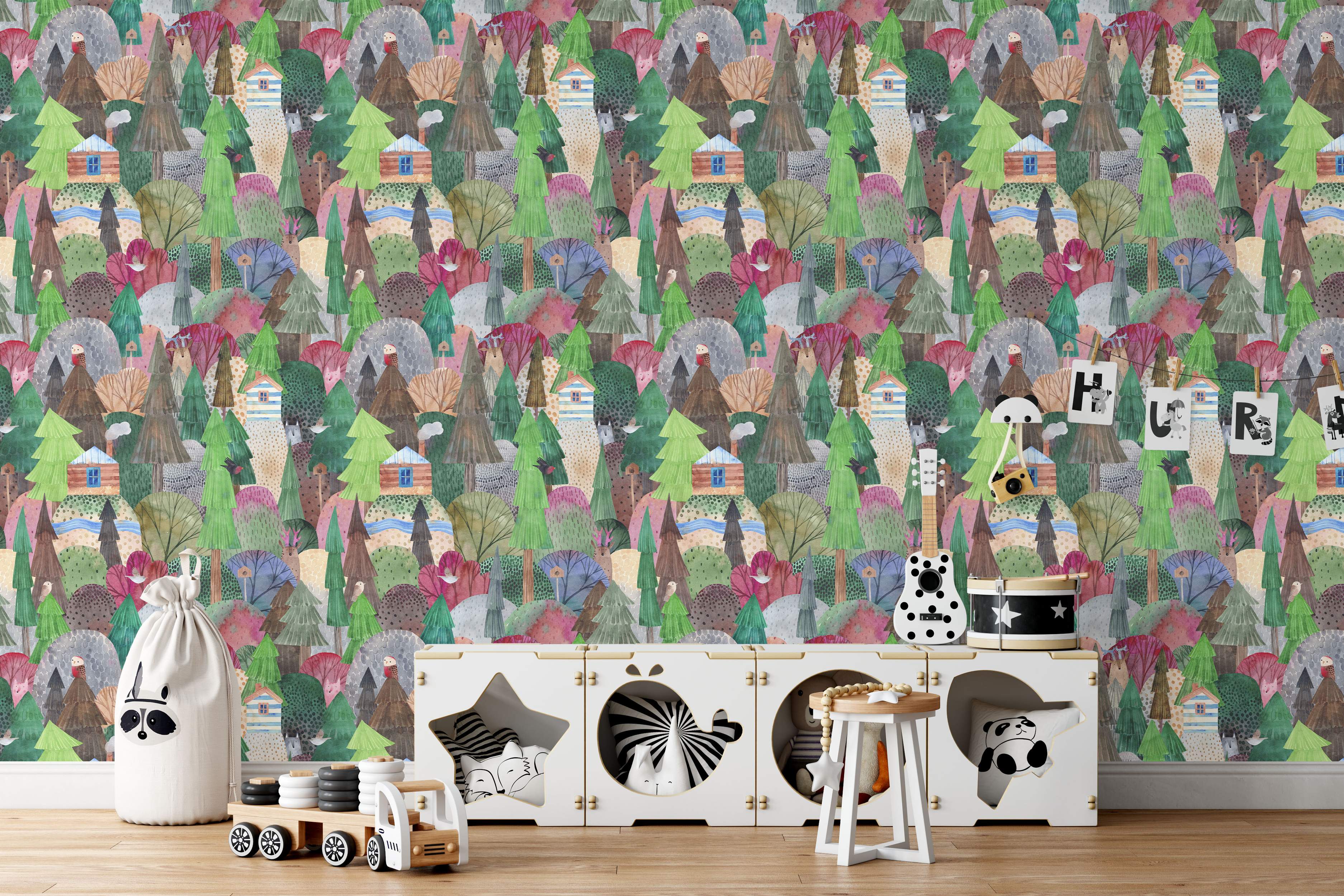 Whimsical watercolor wallpaper featuring a dense forest scene with illustrated trees, log cabins, hills, and animals in green, brown, pink, and blue.