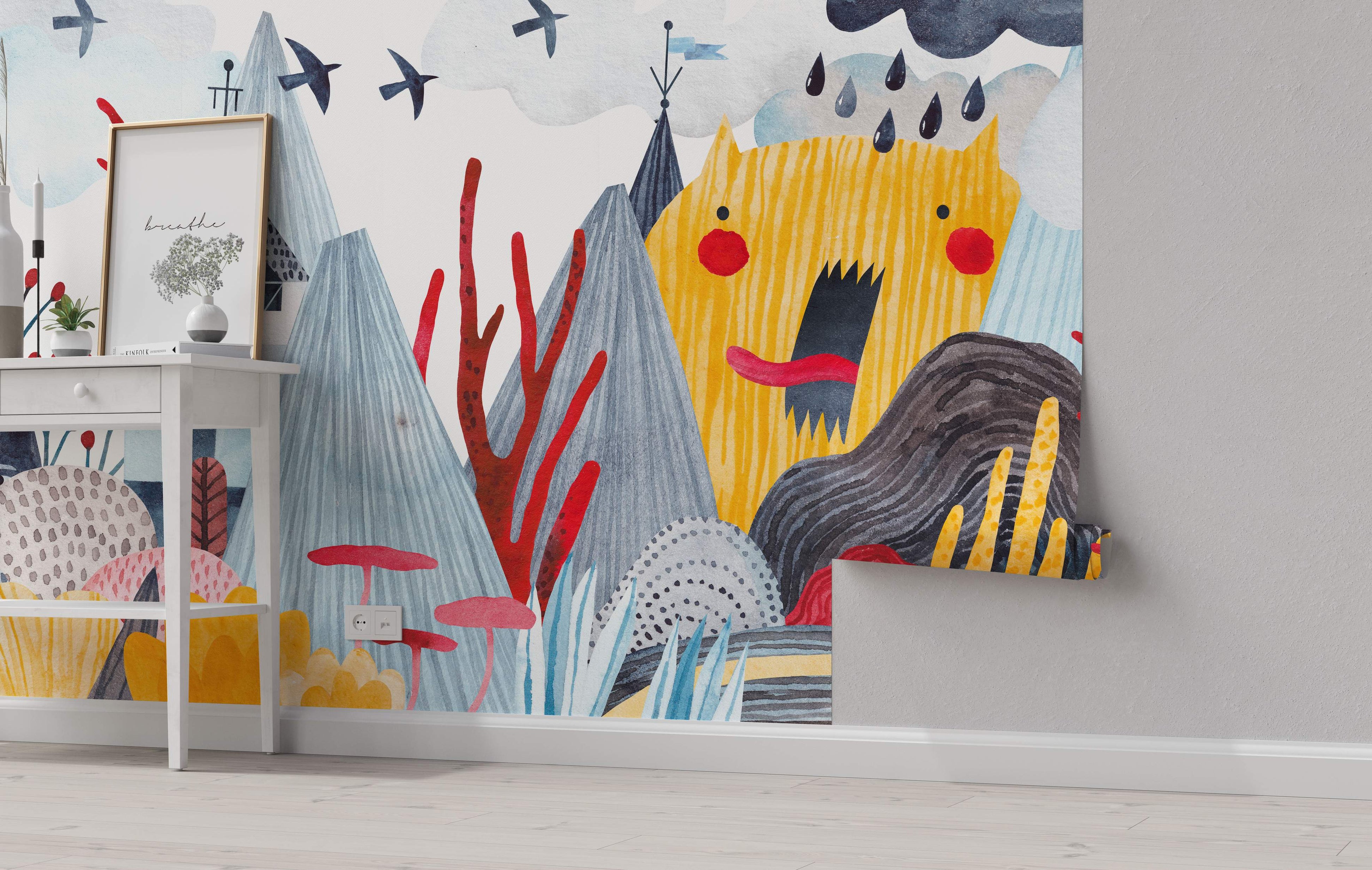 Whimsical watercolor mural featuring a yellow monster, gray mountains, red trees, and birds in a blue and gray landscape.
