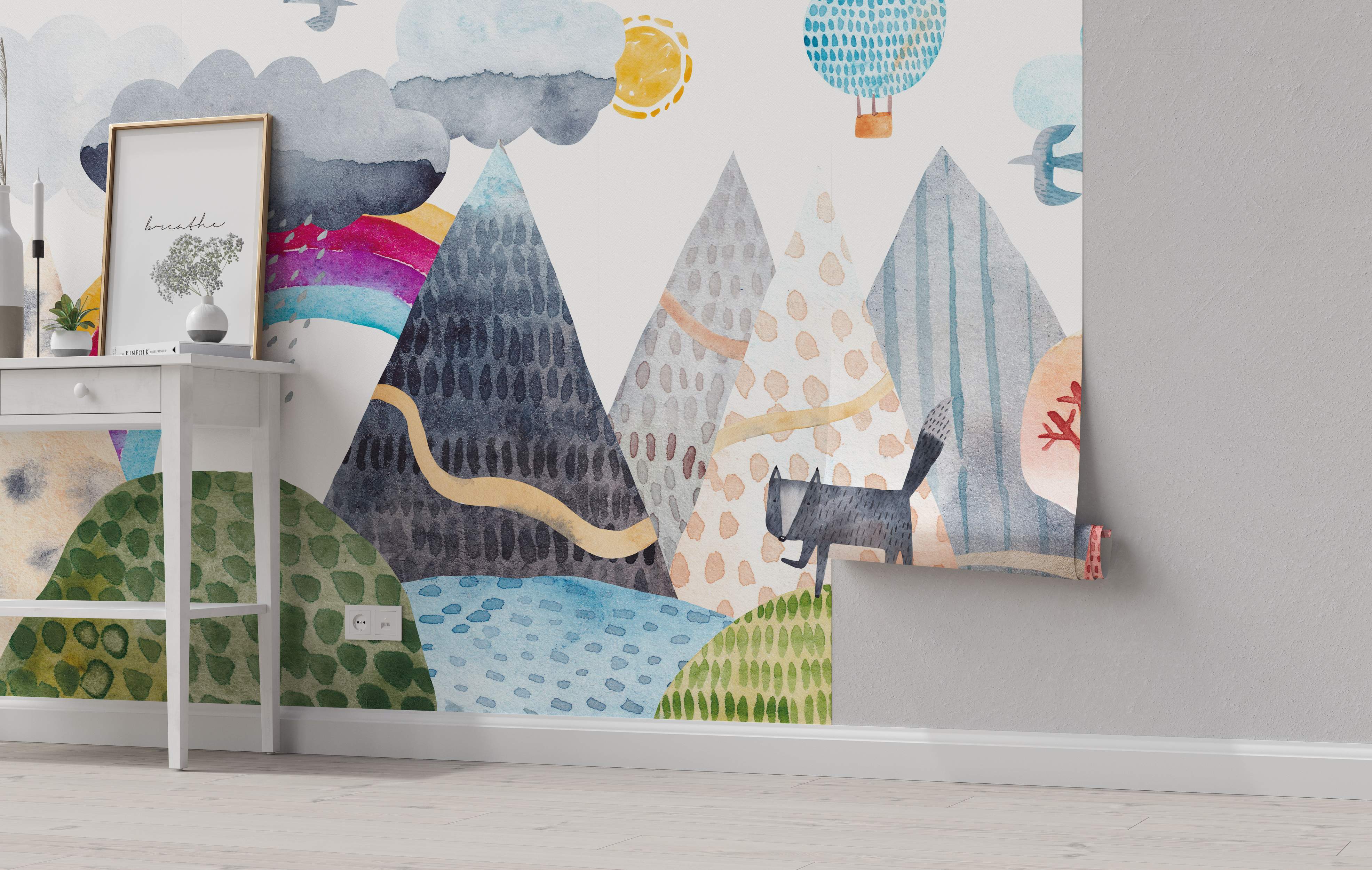 Whimsical watercolor mural featuring abstract mountains, clouds, sun, hot air balloon, and a fox in blues, grays, and greens.