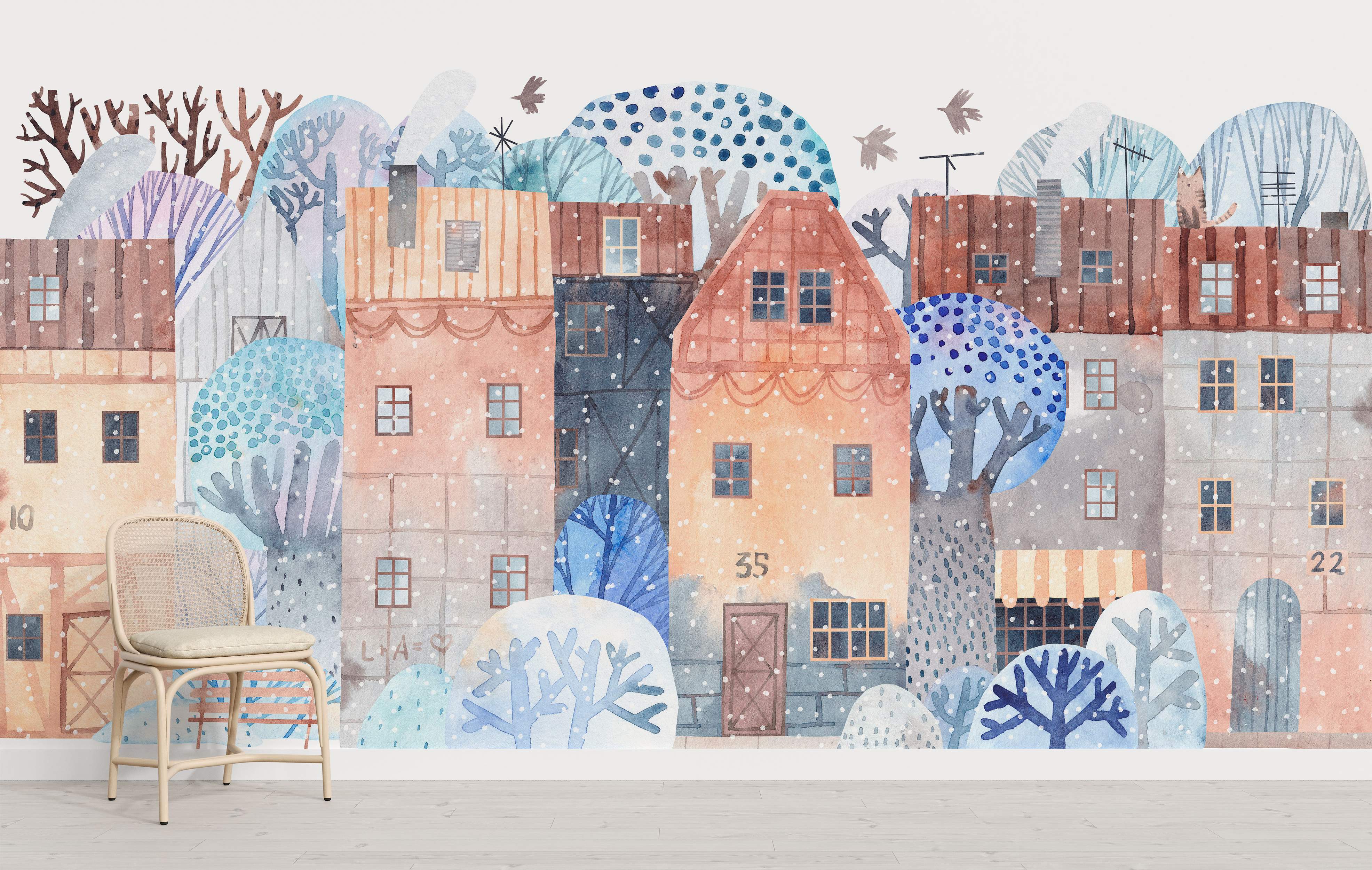 Whimsical watercolor winter town scene mural featuring stylized houses and snowy trees in soft blues, browns, pinks, and greys.