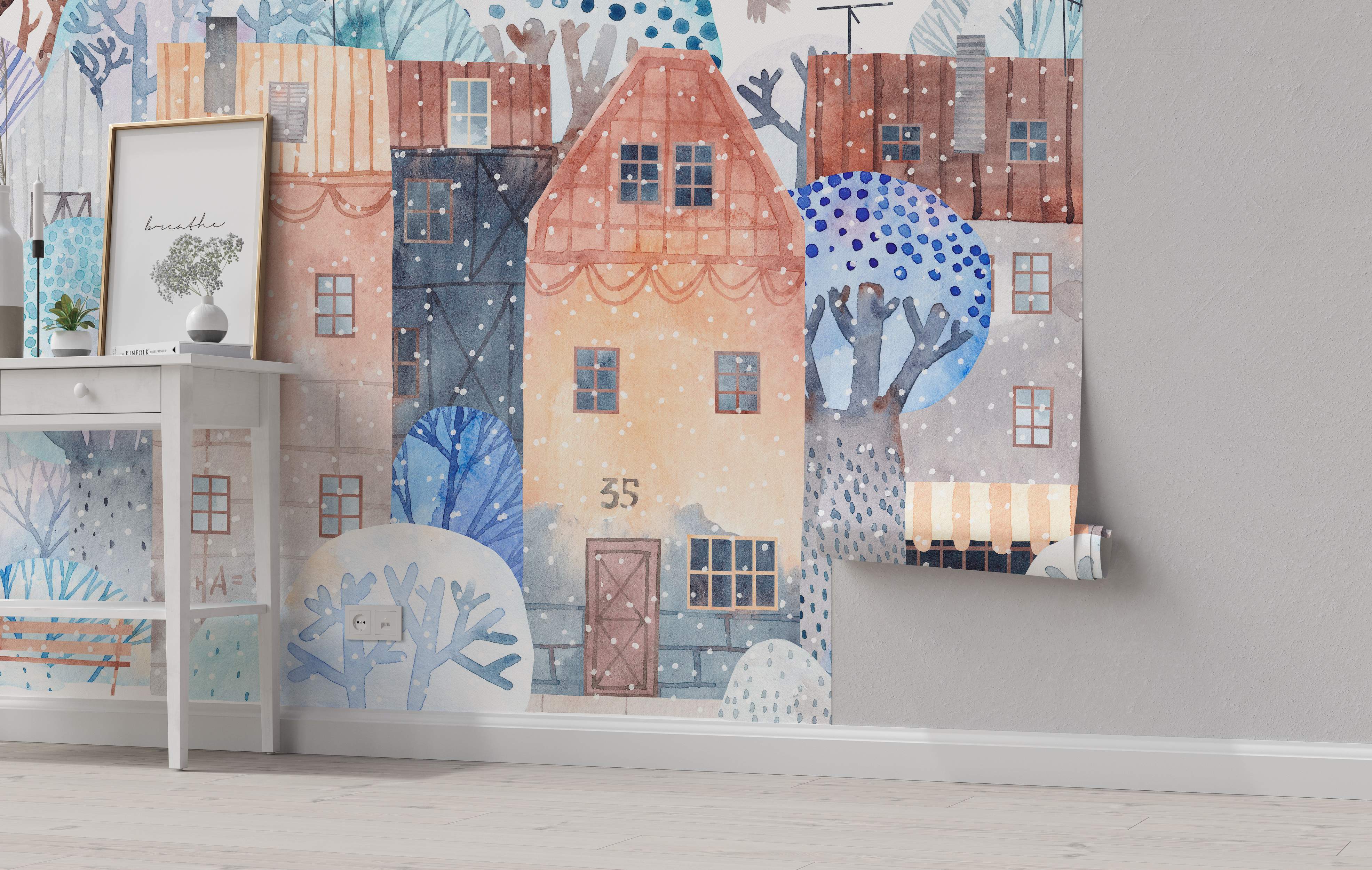Watercolor mural showing a quaint winter village scene with peach, blue, and brown houses, abstract trees, and falling snow.