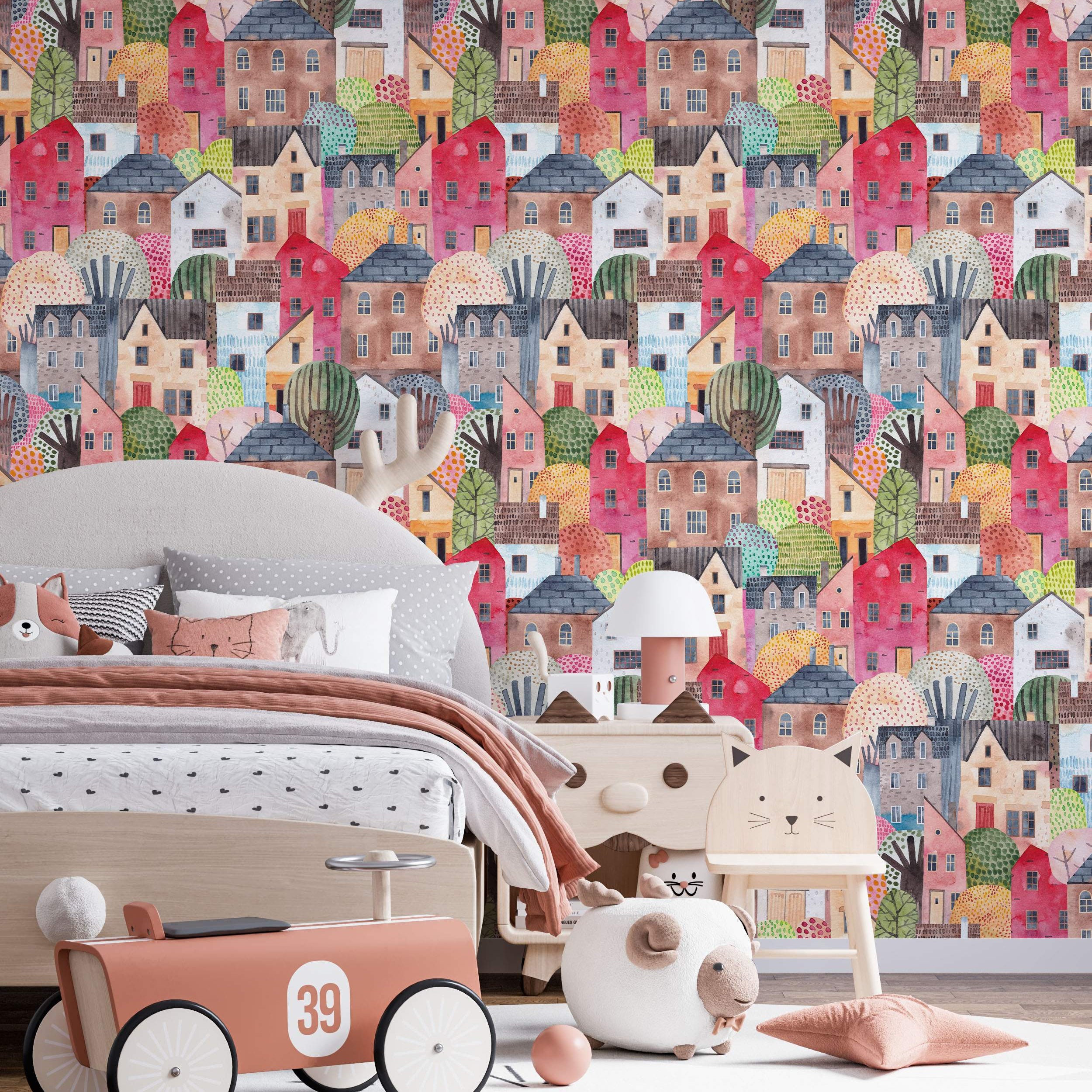 Whimsical wallpaper showing a dense watercolor village with colorful houses and trees in pink, red, brown, and blue hues.