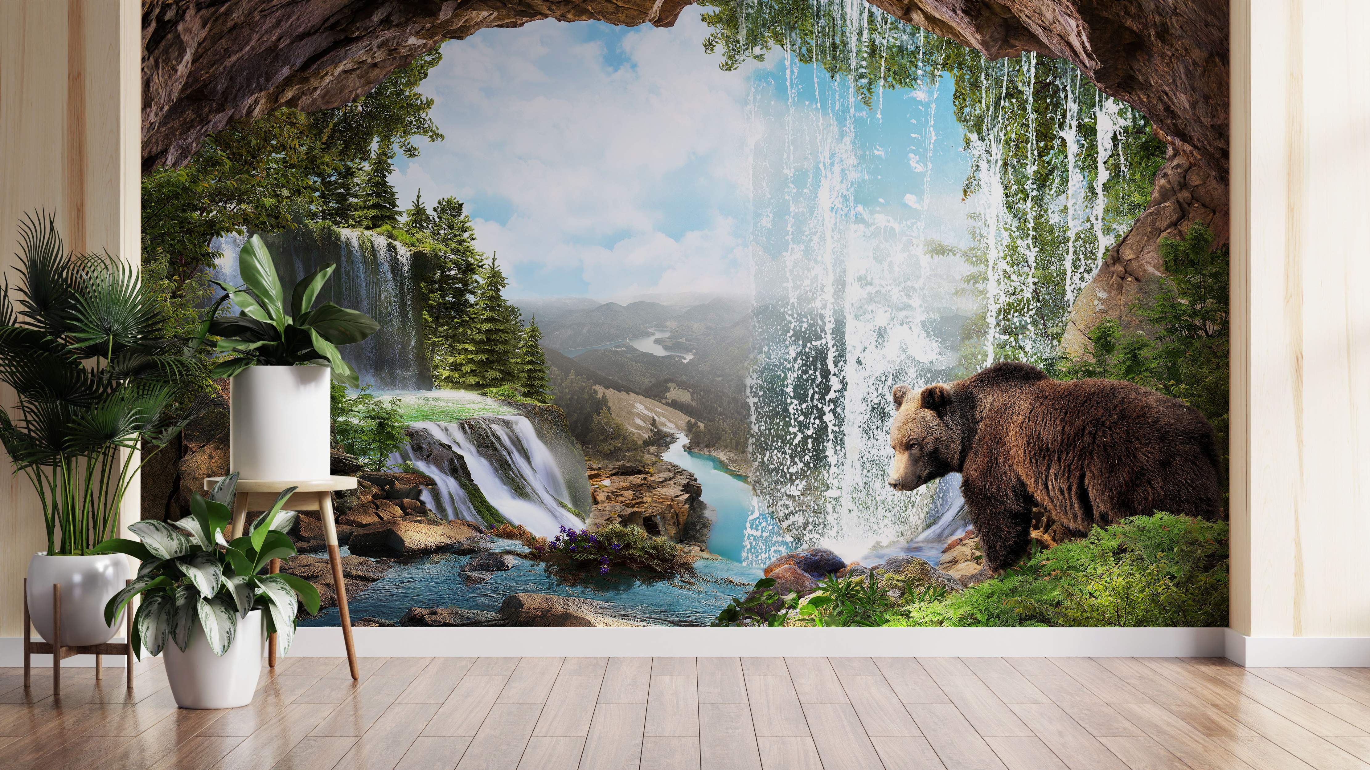 Cave view mural showing waterfalls, a river valley, green trees, and a brown bear near the water under a blue sky.