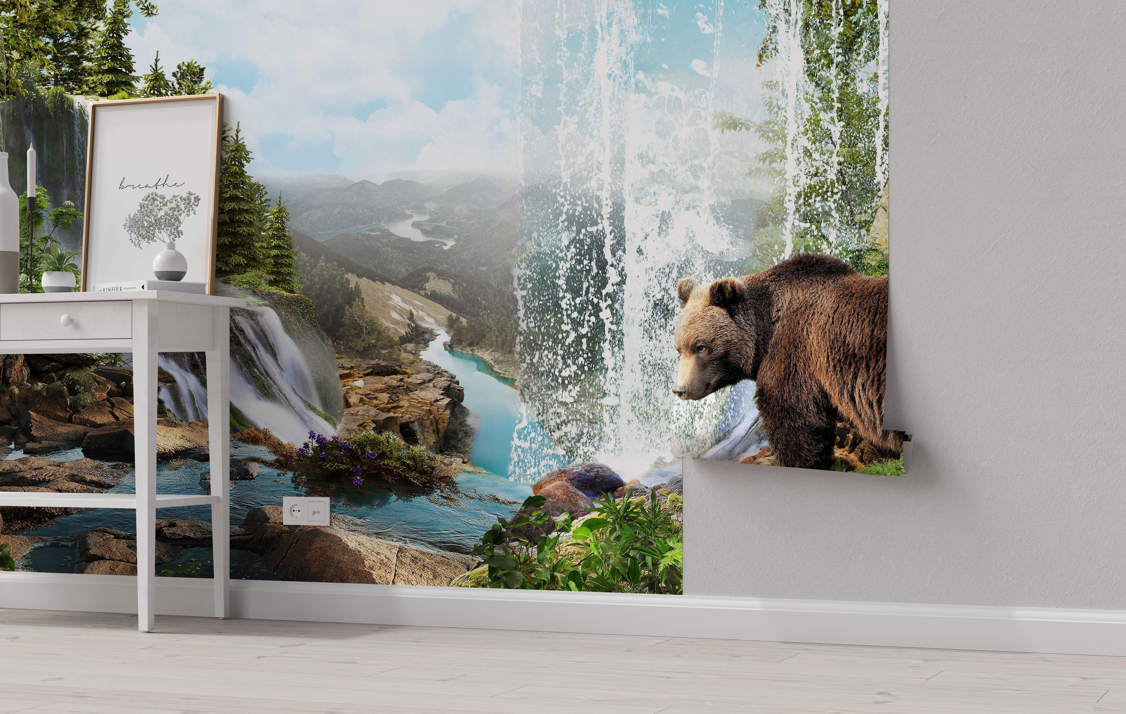 Photorealistic mural depicting a brown bear beside a waterfall, overlooking a turquoise river, green forests, and distant mountains.