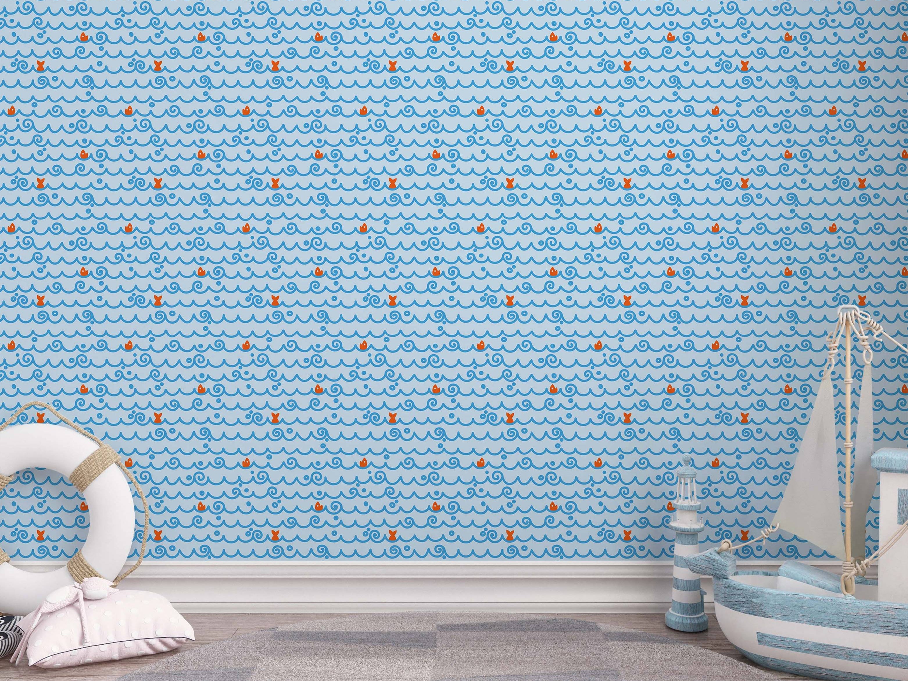 Wallpaper with repeating blue stylized waves, swirls, dots, and small orange fish on a light blue background.